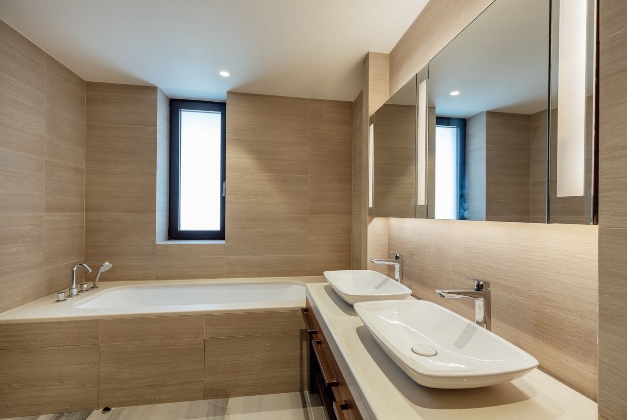 Modern bathroom with two sinks and a bathtub in a villa in Portonovi, Kumbor, Montenegro.