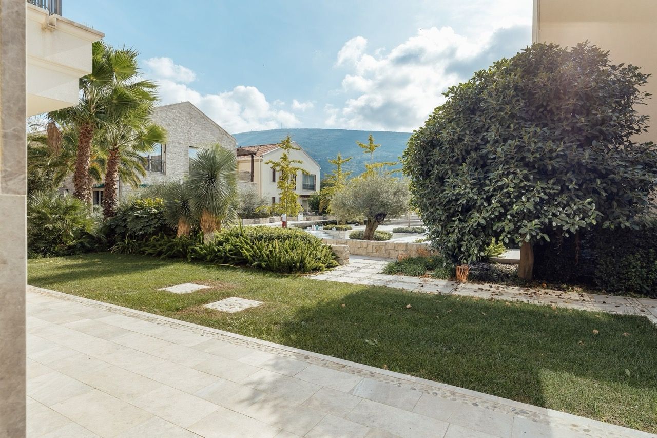 Well-maintained garden and villa terrace in Portonovi, Kumbor, Montenegro with mountain views and landscaped design.
