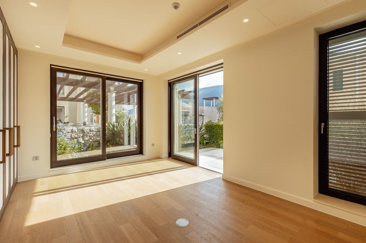Bright living room with panoramic windows and access to the terrace in a villa in Portonovi, Kumbor, Montenegro.