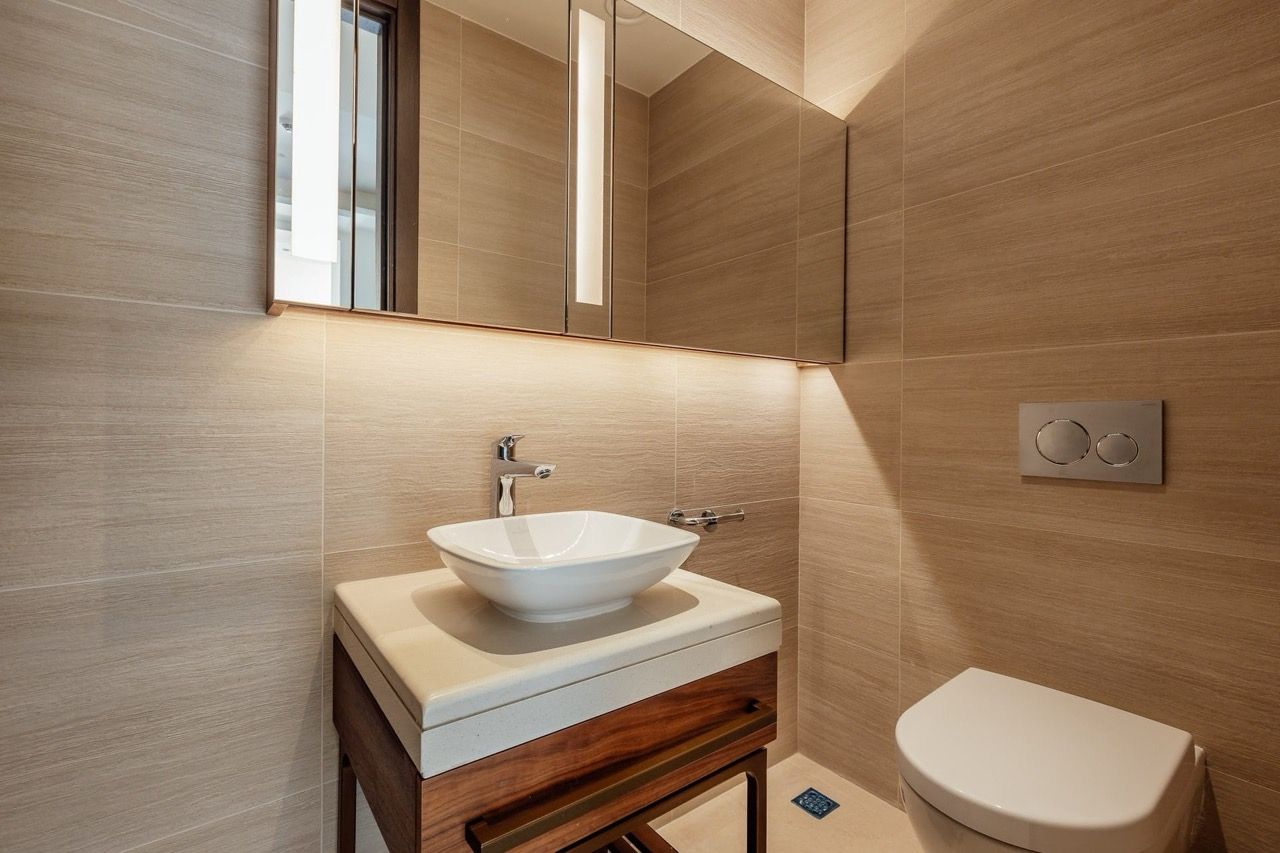 Modern bathroom with beige tiles and a stylish vanity in Portonovi villa, Kumbor, Montenegro