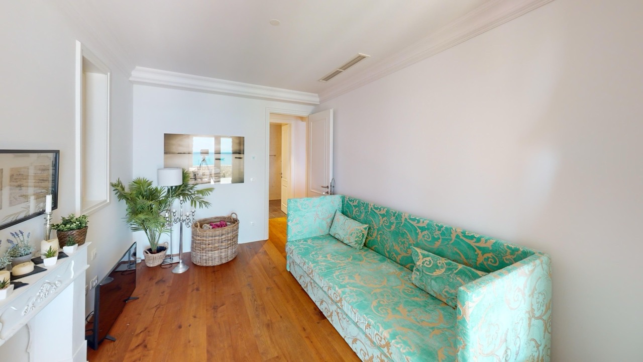 Wohnzimmer mit türkisfarbenem Sofa und Meerblick in den Apartments von Lustica Bay, Radovici, Montenegro.