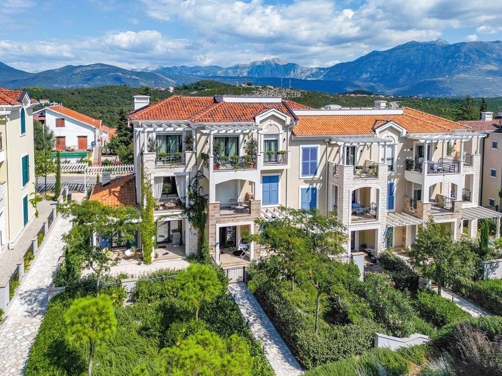 Residential complex in Luštica Bay, Radovići, Montenegro: view of modern apartments with terraces and a green garden.