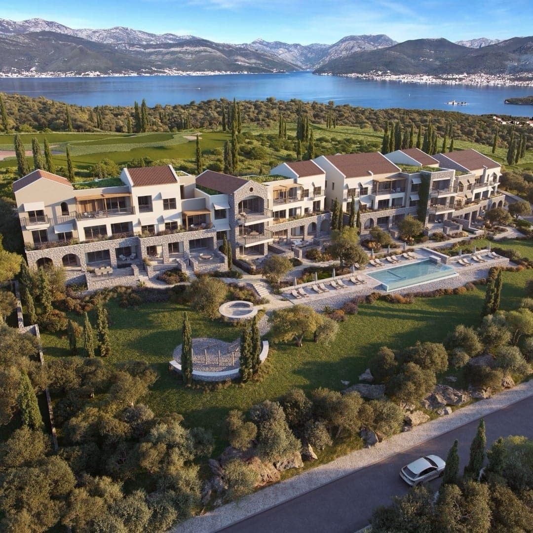 Luxury residential complex in Luštica Bay, Montenegro: view of villas, a pool, and a bay panorama with mountain scenery.