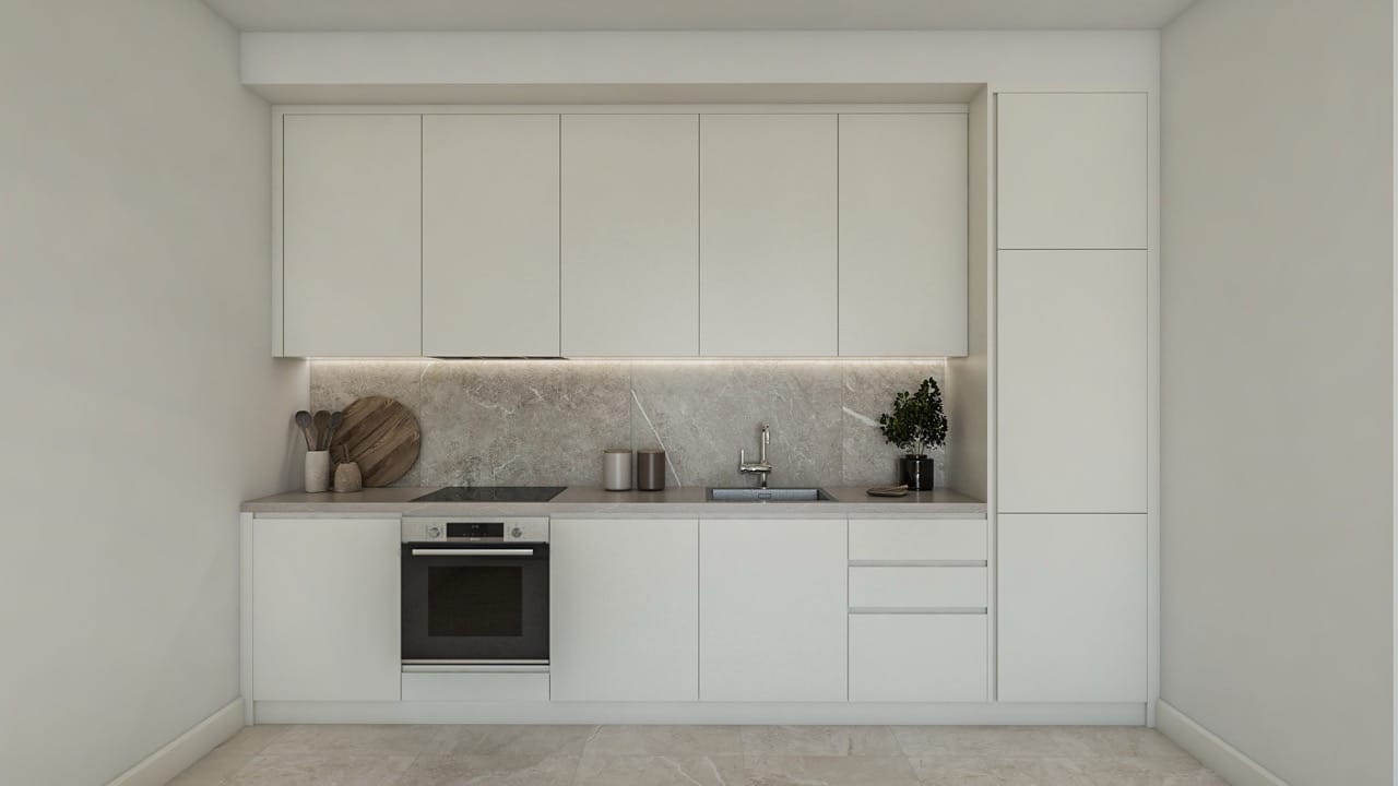 Modern bright kitchen in an apartment in Luštica Bay, Radovići, Montenegro: built-in appliances and stone backsplash.