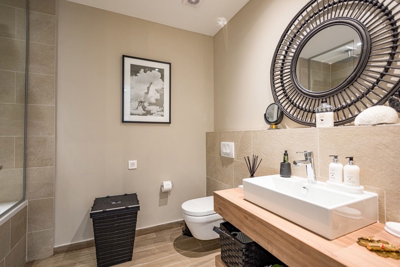 Modern bathroom in an apartment in Luštica Bay, Radovići, Montenegro: stylish fixtures and rattan decor.