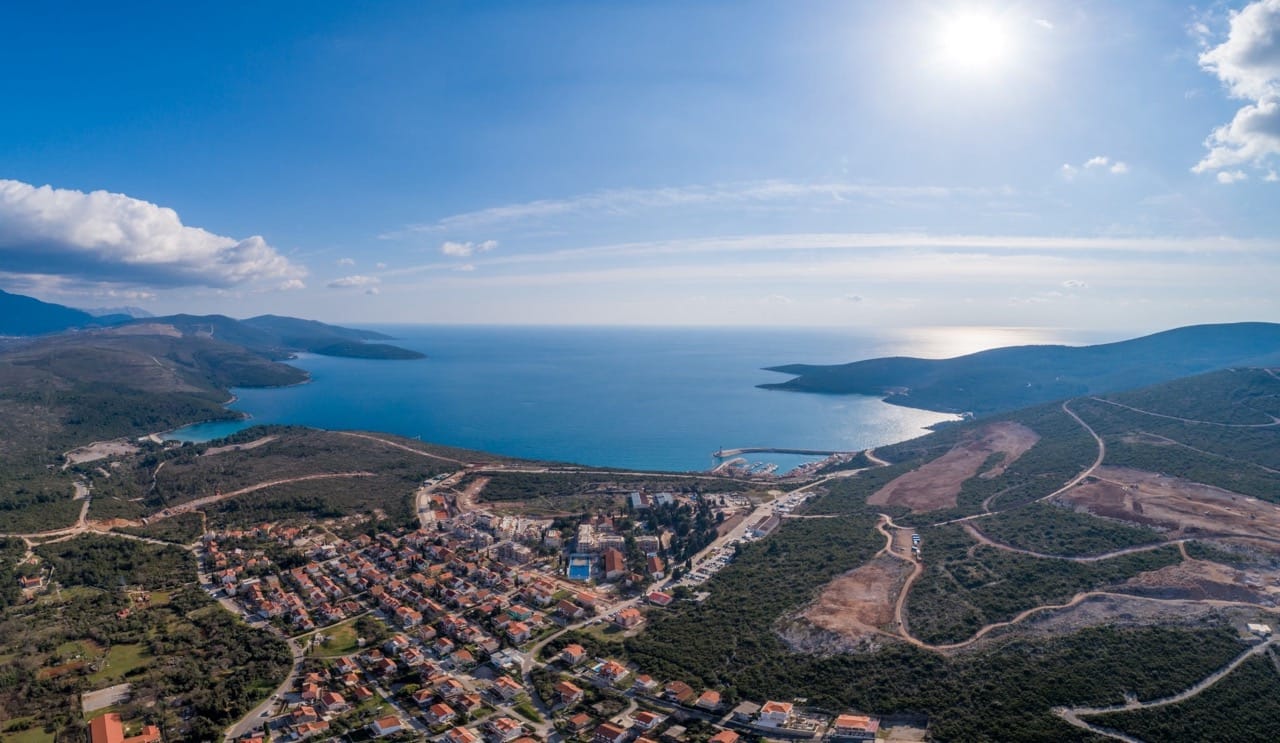 Aerial panoramic view of Luštica Bay resort and the village of Radovići, Montenegro, with the sea coast and mountains.