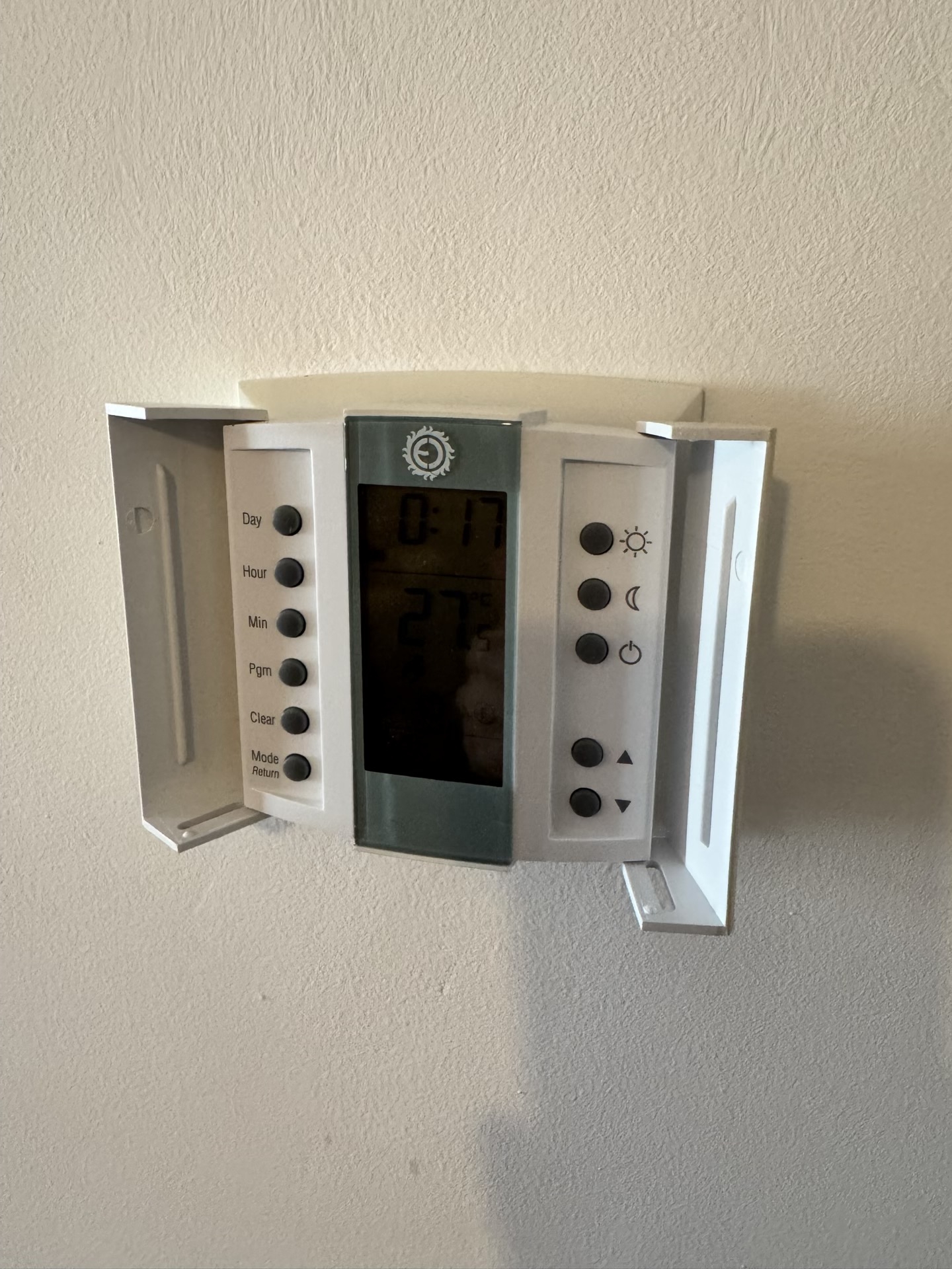 Digital thermostat for climate control in an apartment in Budva, Montenegro, on a light wall.
