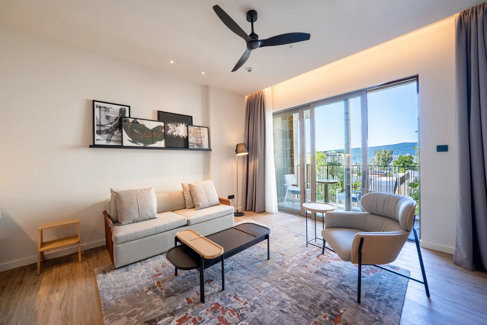 Modern living room in Porto Montenegro apartments, Tivat: stylish furniture, panoramic windows, and sea view in Montenegro