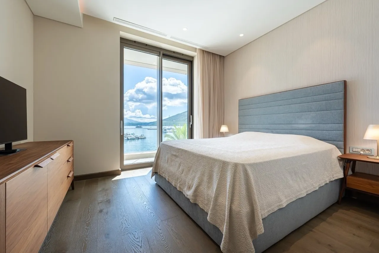 Modernes Schlafzimmer in Portonovi, Kumbor, Montenegro mit Meerblick, Doppelbett und Holzmöbeln.