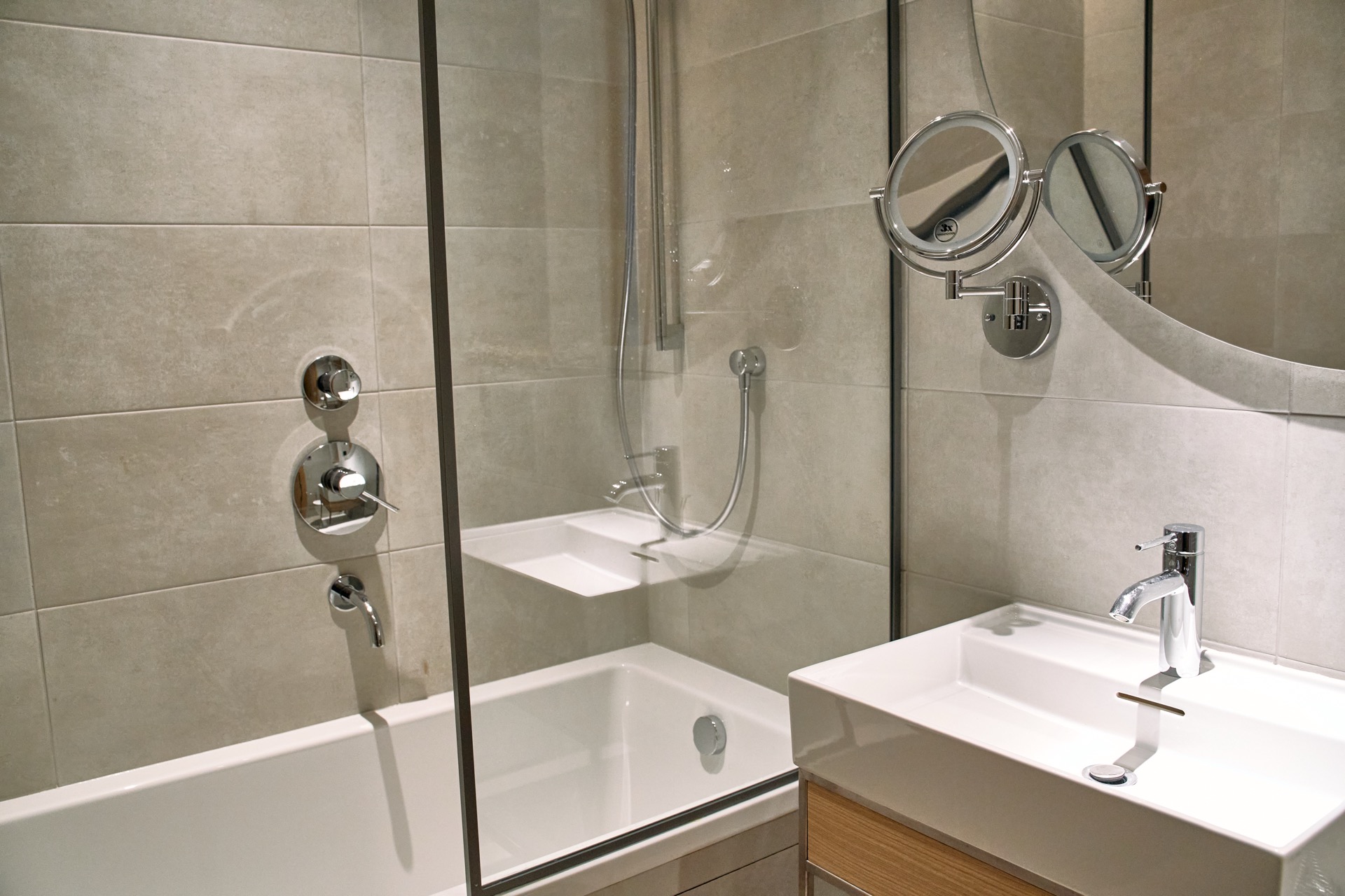 Modernes Badezimmer in einer Wohnung in Porto Montenegro, Tivat, Montenegro: Duschkabine, Sanitäranlagen und Spiegel.