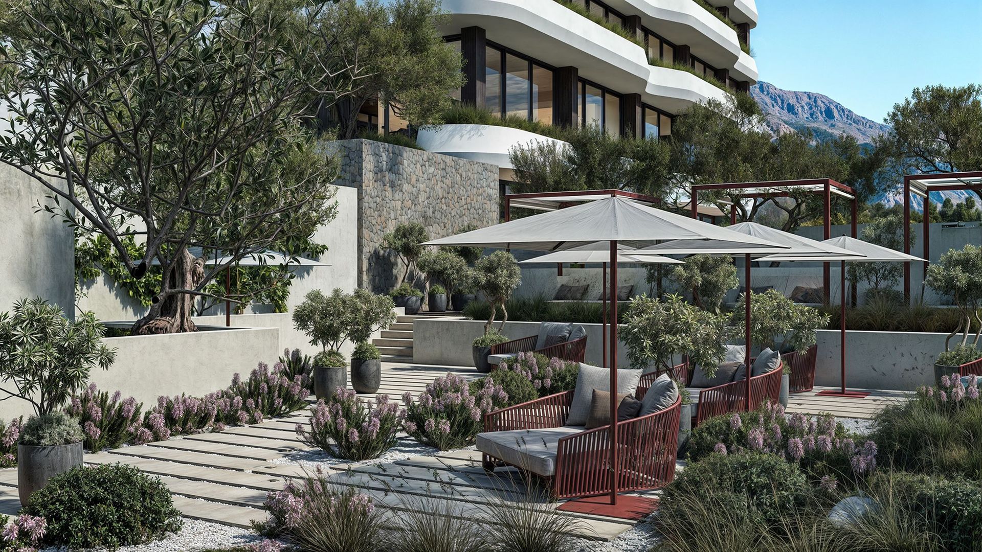 Terrasse aménagée avec espace lounge et jardin dans un complexe résidentiel haut de gamme à Reževići, Monténégro.