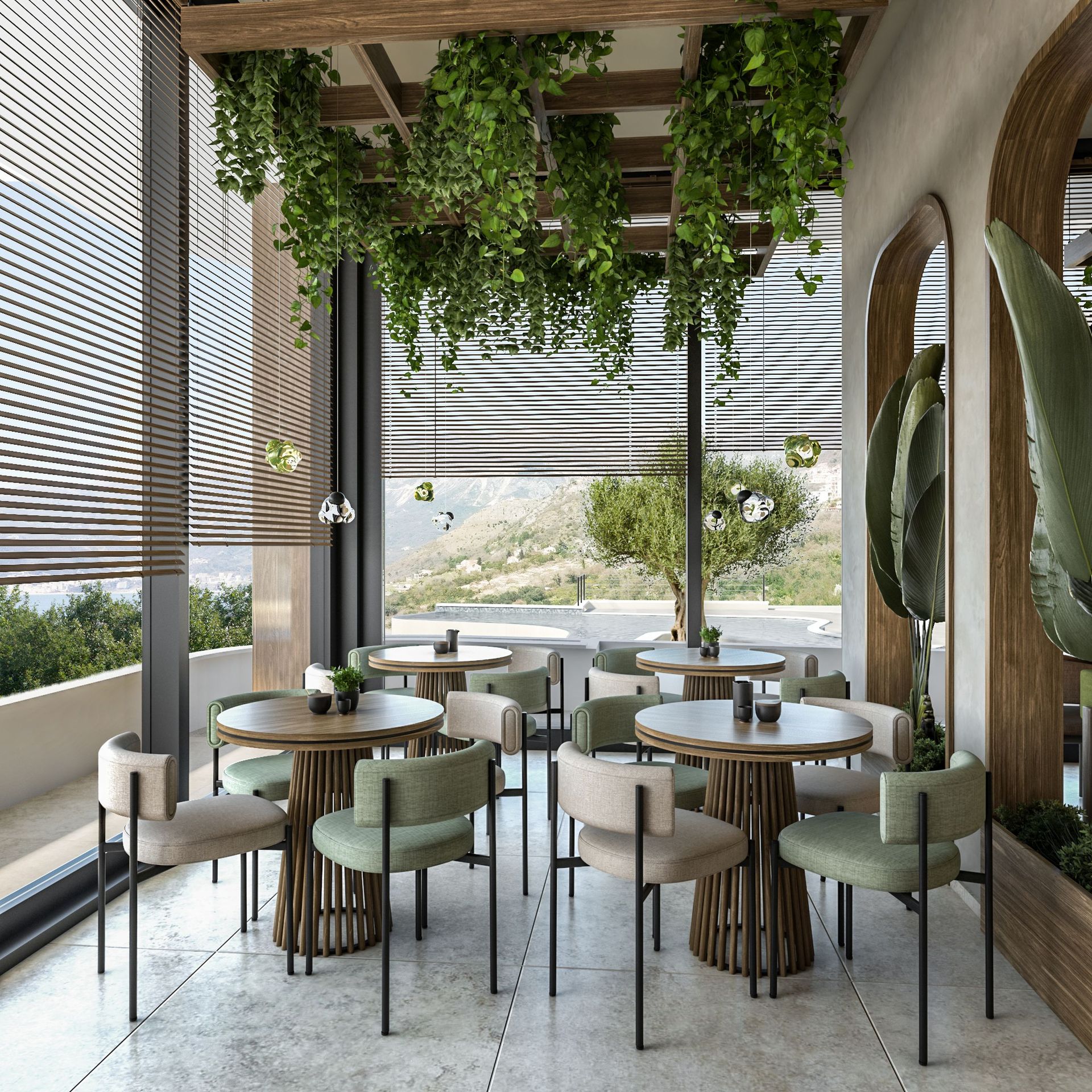 Terrasse design du restaurant dans le complexe résidentiel Reževići, Monténégro : tables rondes, chaises moelleuses et vue sur les montagnes et la mer.