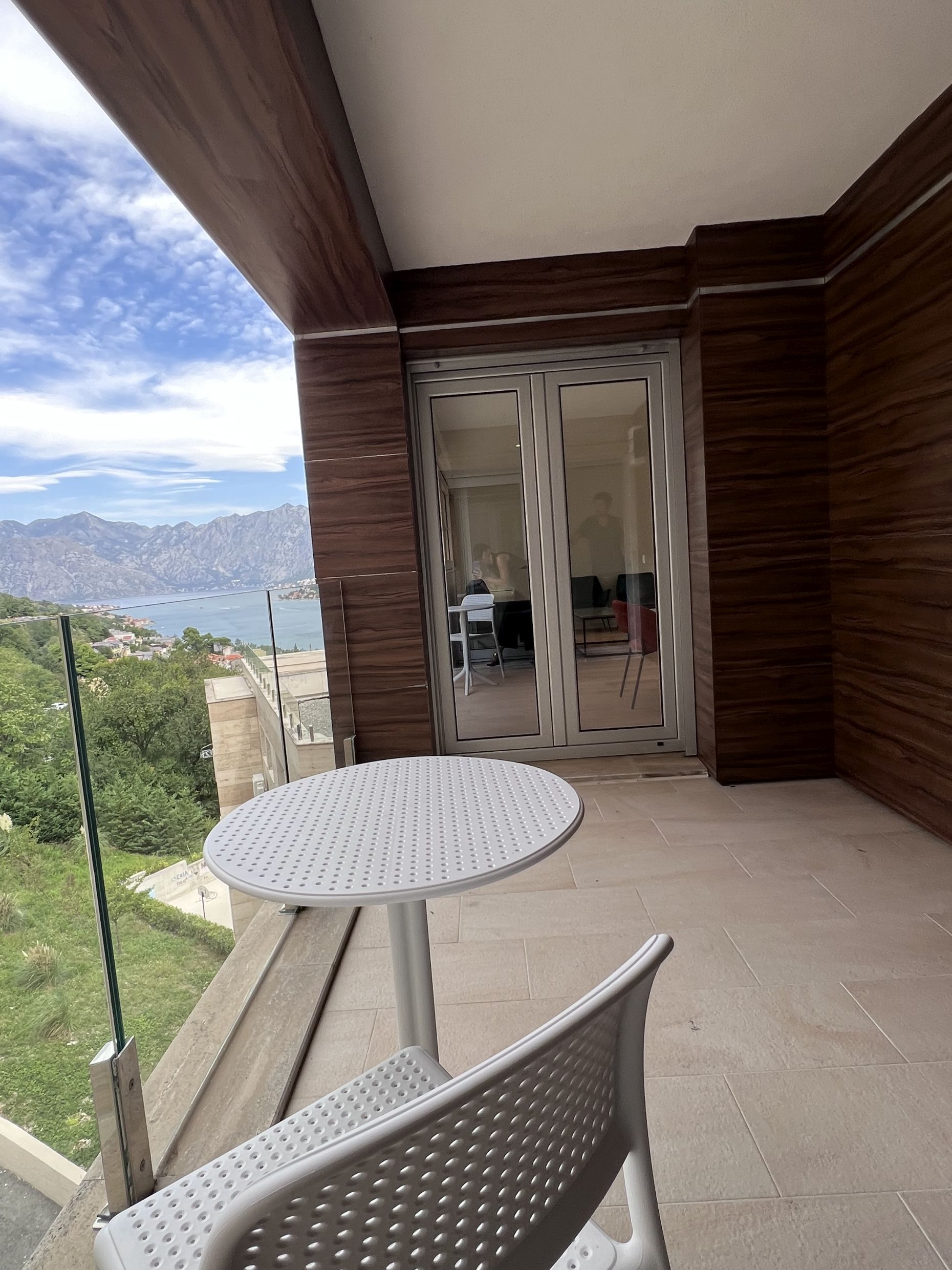 Balkon der Wohnung in Kotor, Montenegro: Panoramablick auf die Bucht von Kotor, moderne Ausstattung und Gartenmöbel.