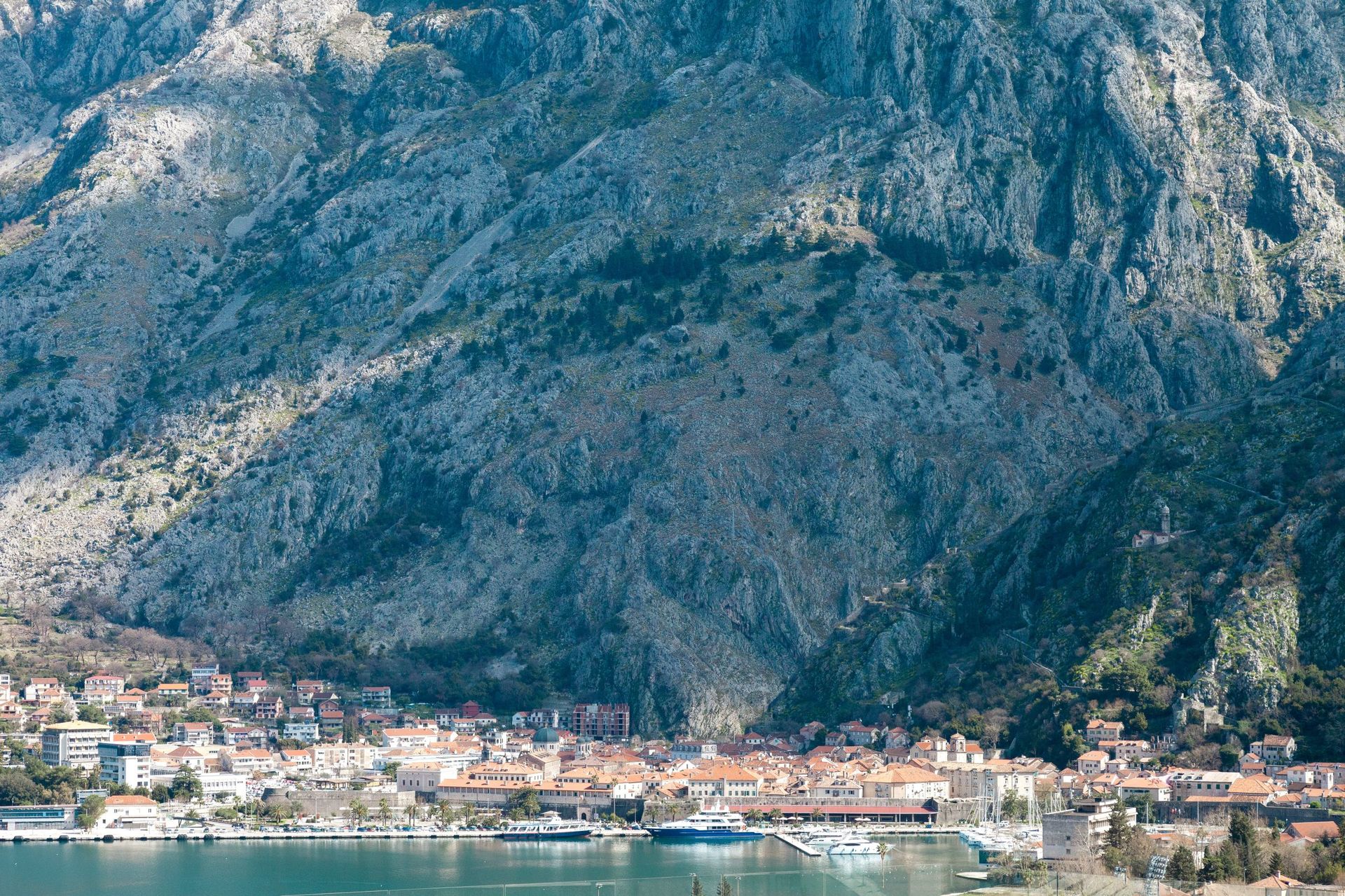Panoramablick auf die Stadt Kotor und die Berge in Montenegro, Blick auf den Seehafen und die historische Architektur von der Uferpromenade aus.