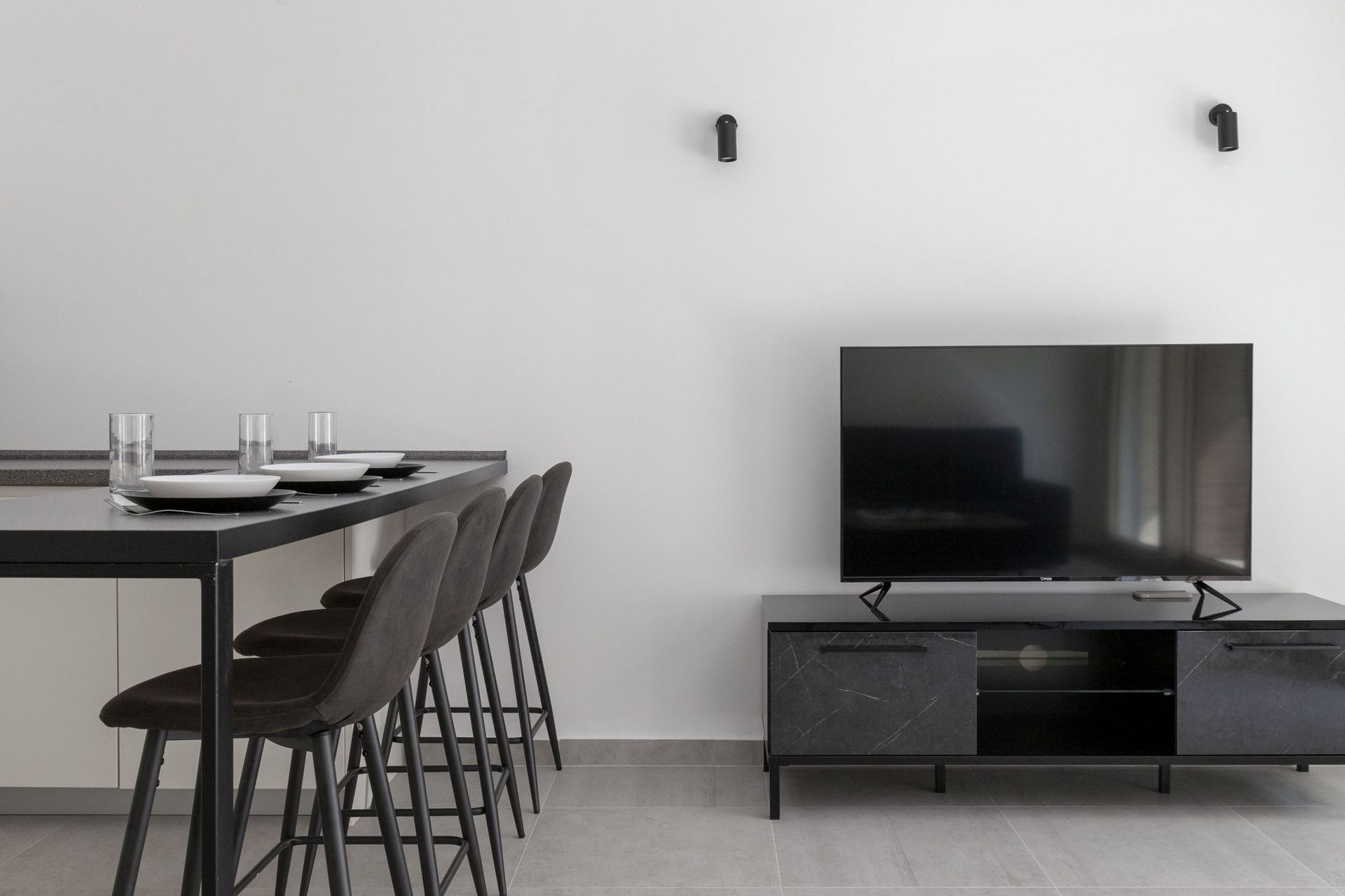 Modernes Wohnzimmer mit Bartheke und TV-Bereich in einer Wohnung in Kotor, Montenegro: stilvolles Interieur im Loft-Stil.