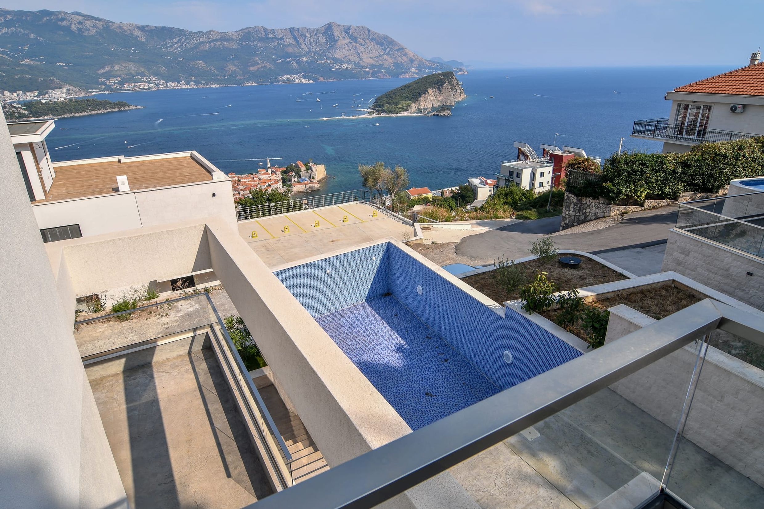 Blick auf den Pool und das Meer von der Terrasse der Villa in Budva, Montenegro: Panorama der Insel Sveti Nikola und der Altstadt.