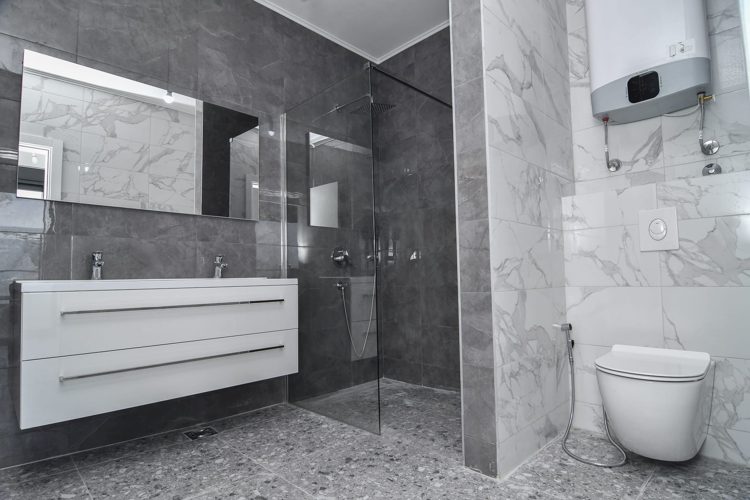 Modernes Badezimmer mit Duschkabine und Marmoroptik in einer Villa in Budva, Montenegro.