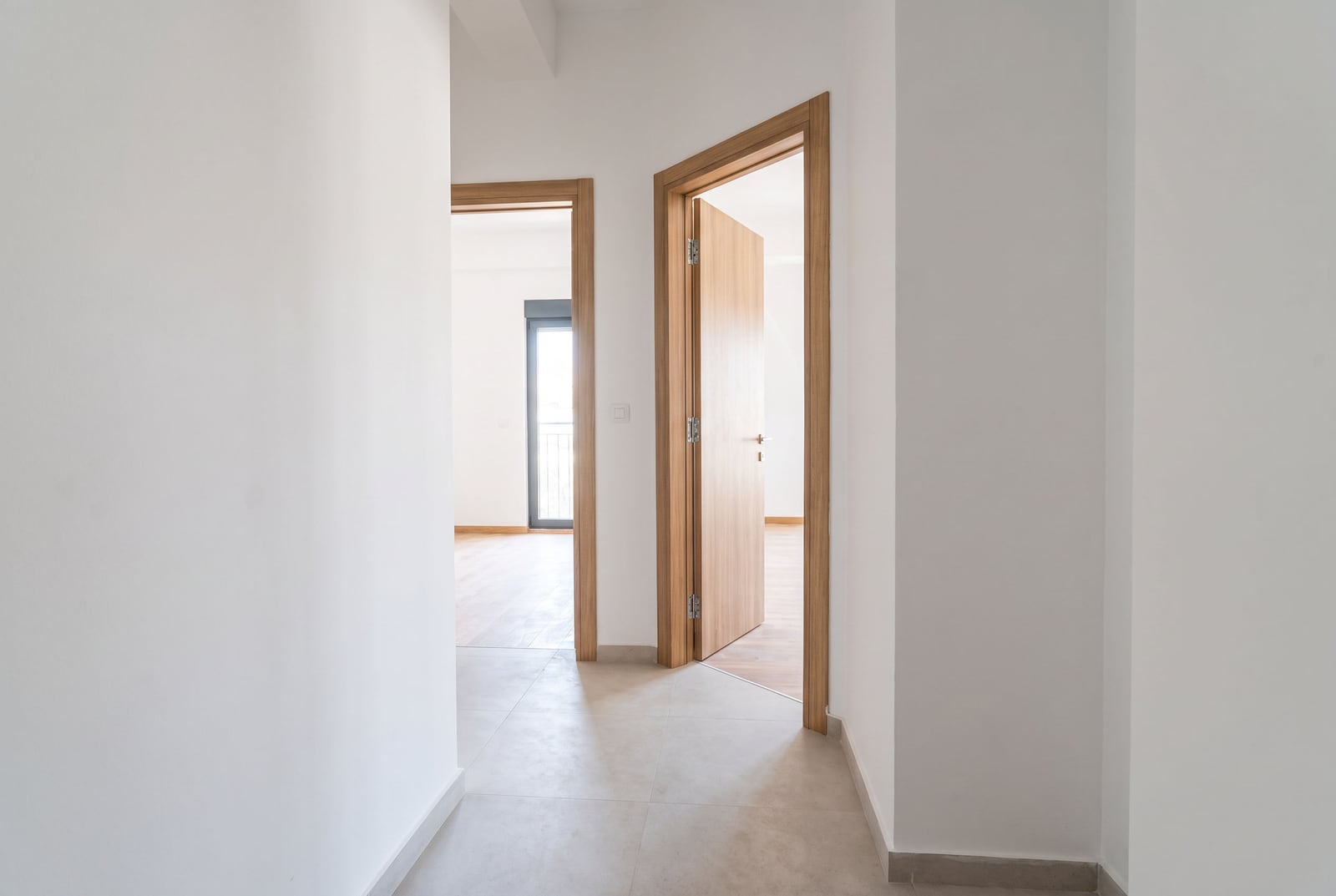Bright hallway with interior doors made of light wood in a new apartment in the city of Bar, Montenegro.