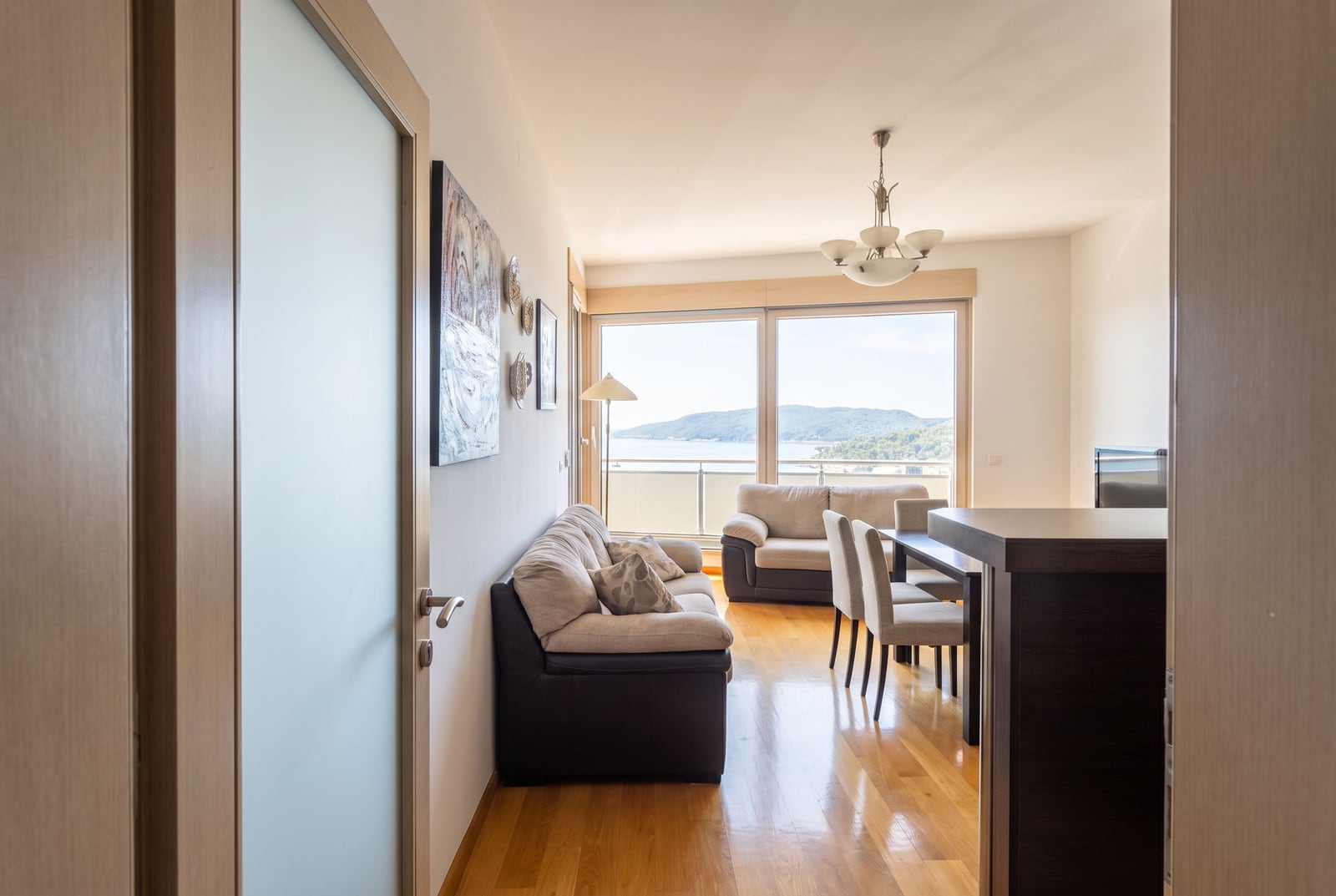 Modern living room with panoramic windows and sea view in an apartment in Bečići, Montenegro