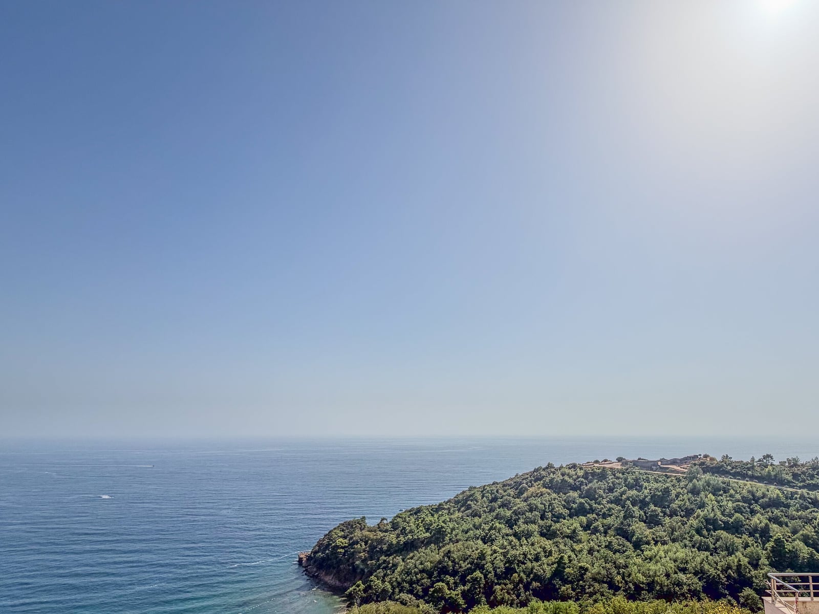 Panoramic view of the sea and a green cape from the balcony of an apartment in Budva, Montenegro