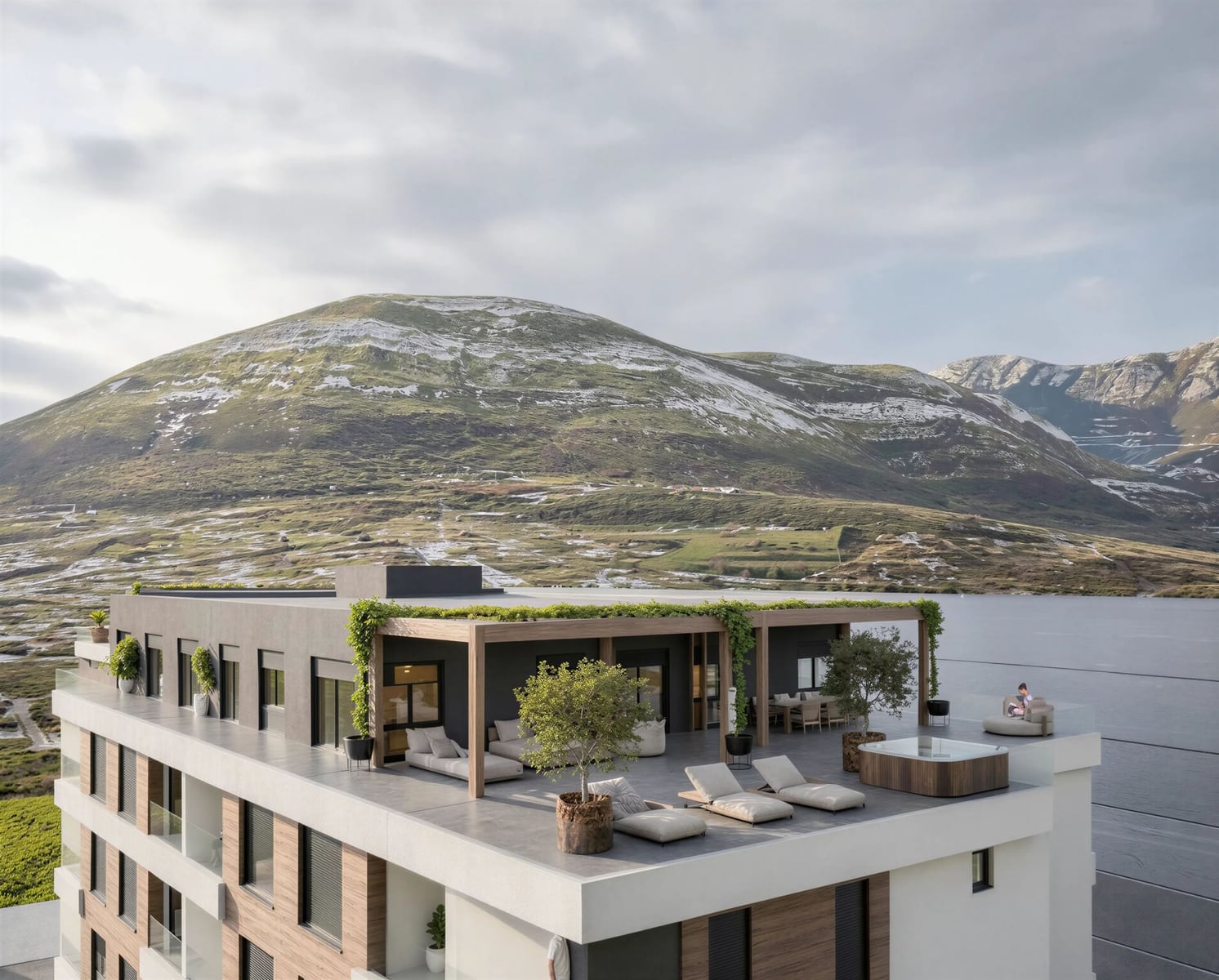 Penthouse-Terrasse mit Whirlpool und Sonnenliegen in einer Wohnanlage in Bar, Montenegro, mit Panoramablick auf die Berge und das Meer.