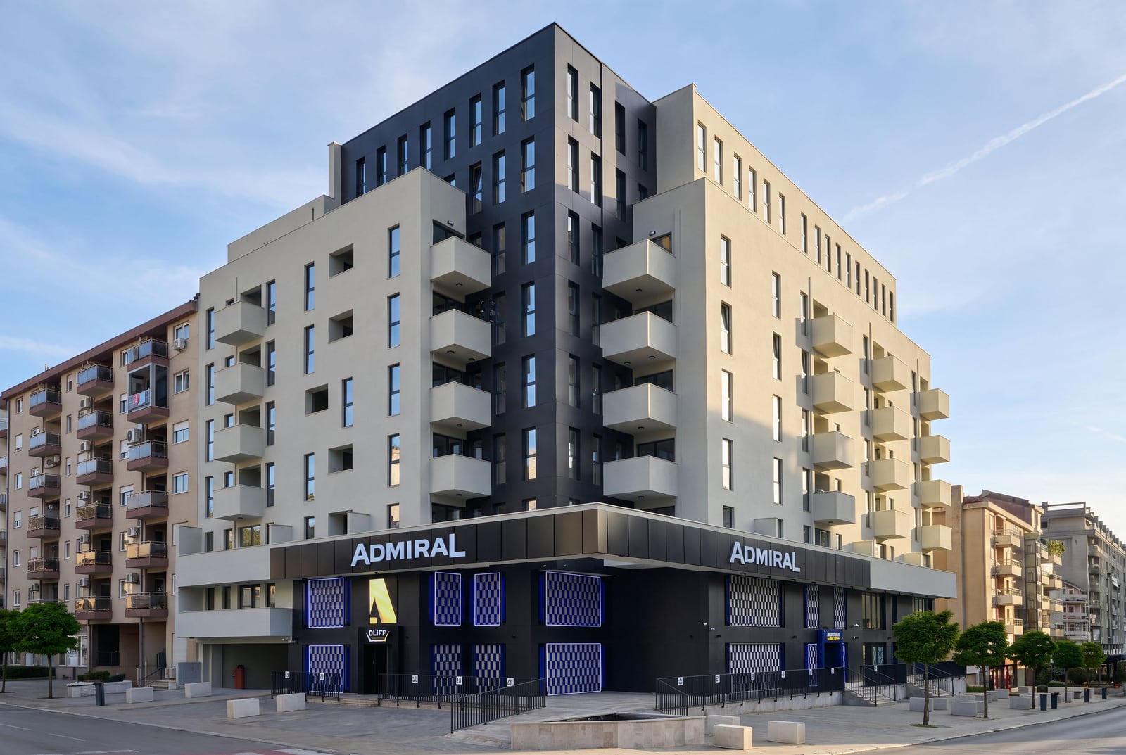 Modern multi-storey residential building with balconies and a commercial space on the ground floor in Budva, Montenegro