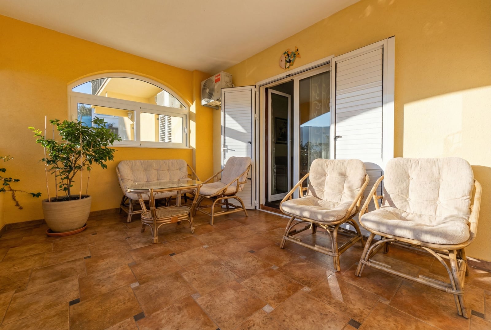 Cozy furnished terrace with rattan armchairs and a sofa in an apartment, Igalo, Montenegro