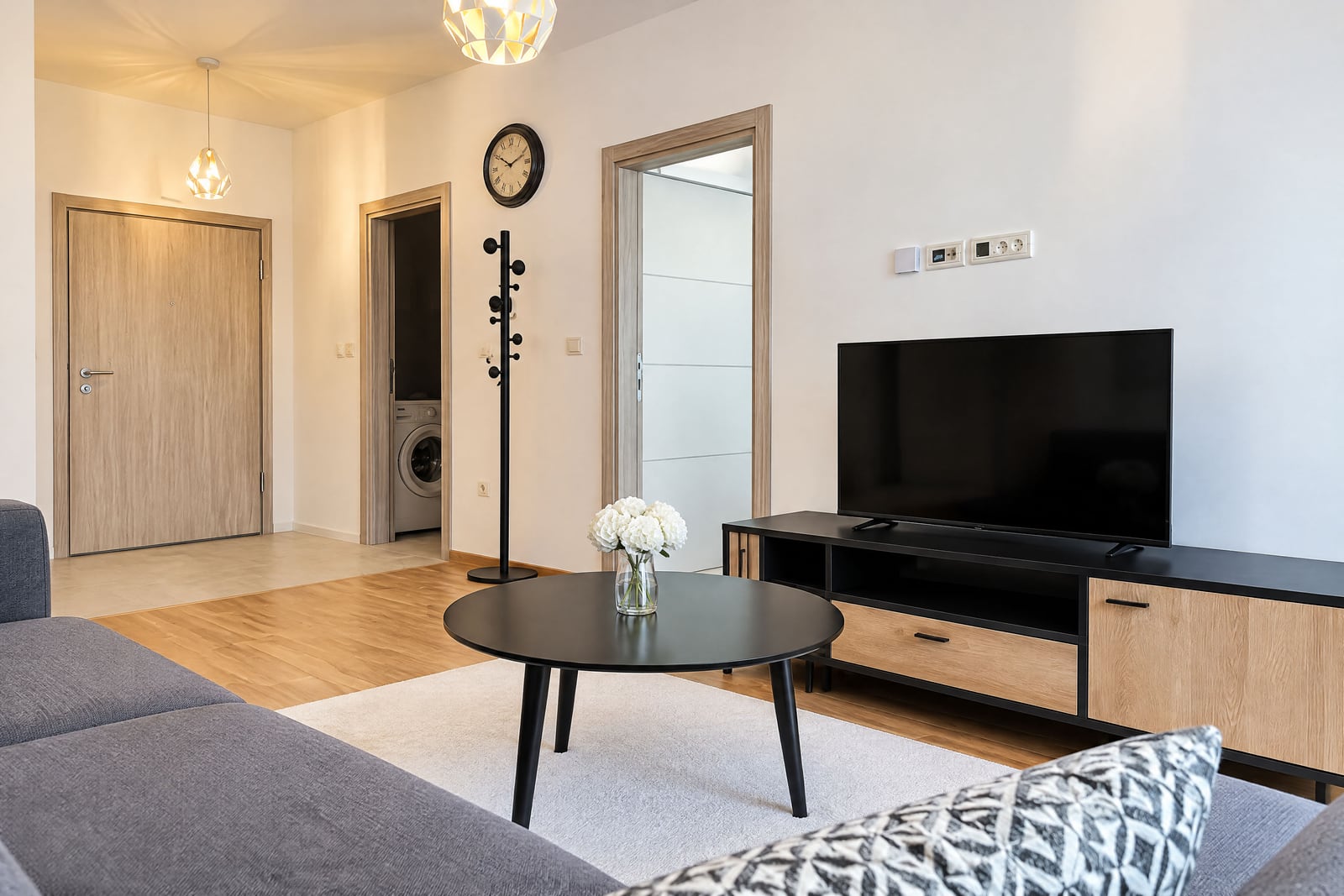 Modern living room with a TV, sofa, and coffee table in an apartment in Budva, Montenegro