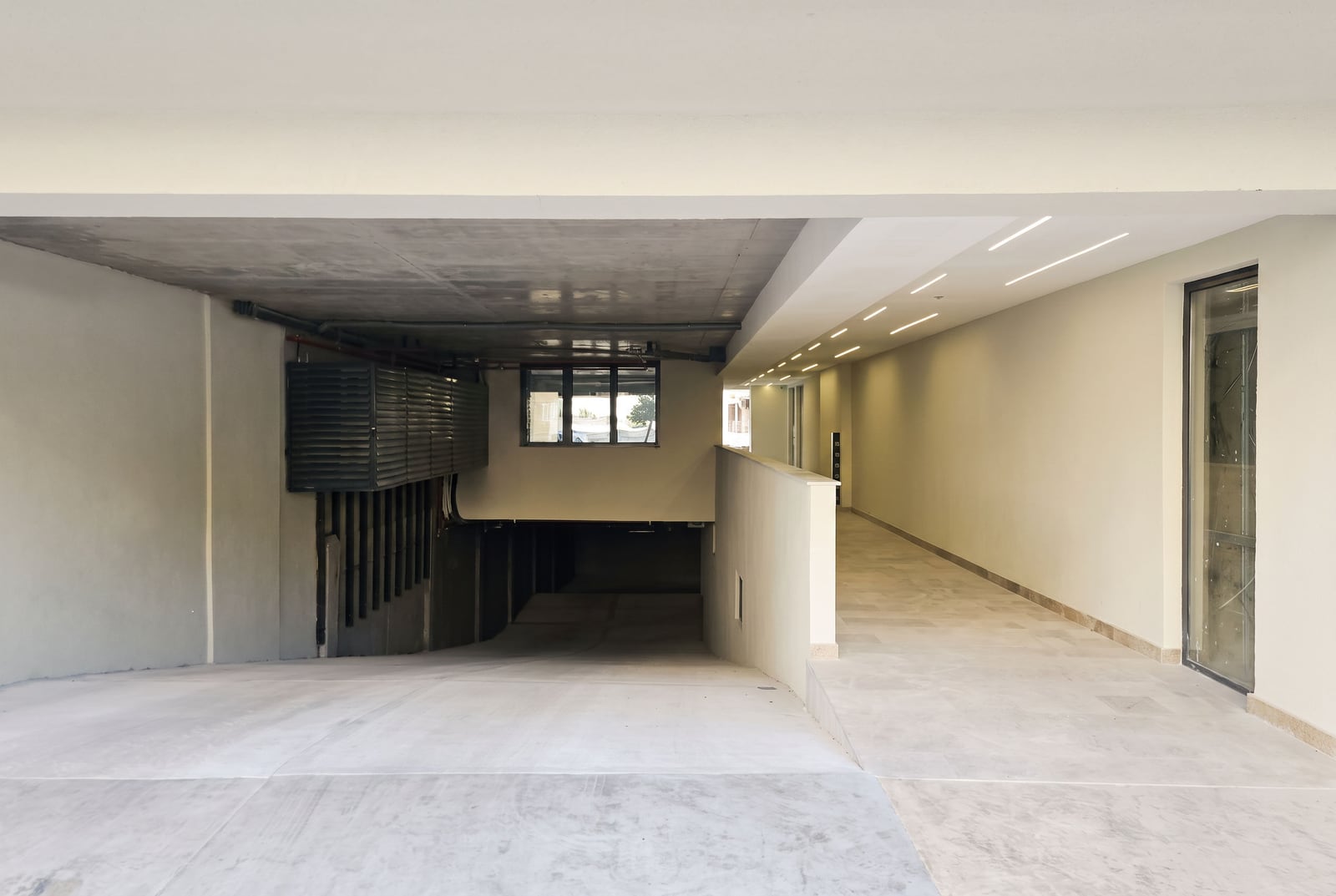 Entrance to the underground parking and modern entrance area of a residential building in Budva, Montenegro
