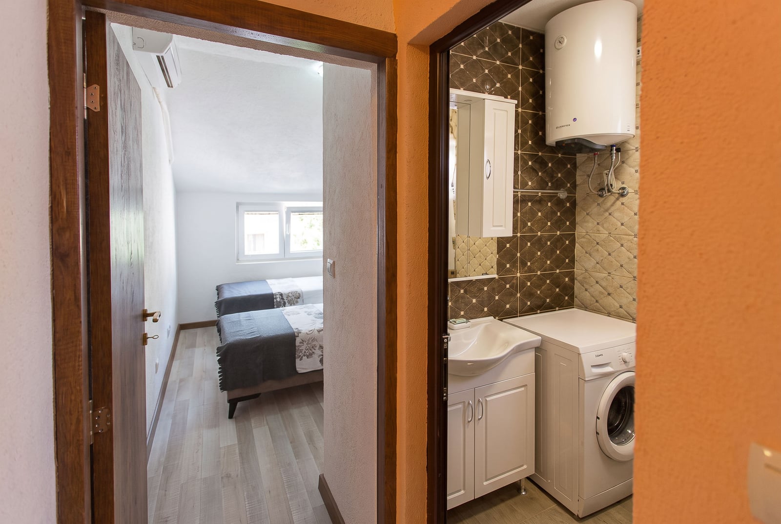 Combined bathroom with water heater and washing machine in an apartment in Budva, Montenegro