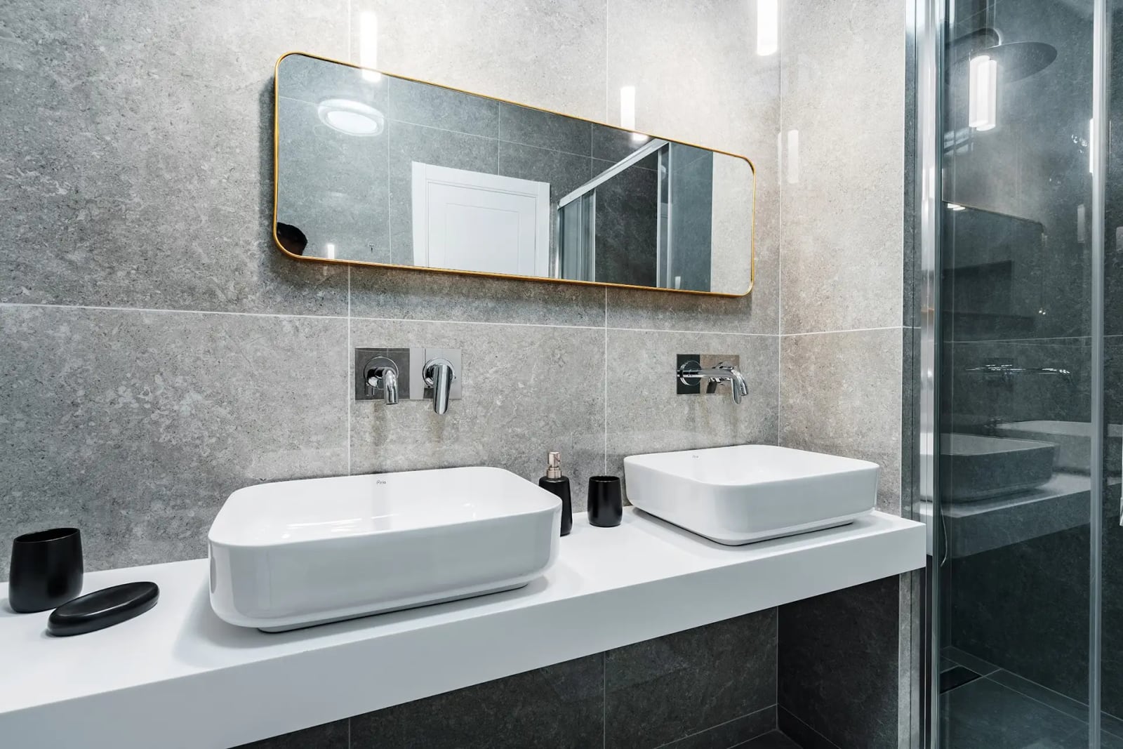 Modern bathroom with double vanity and walk-in shower in a villa in Reževići, Montenegro.