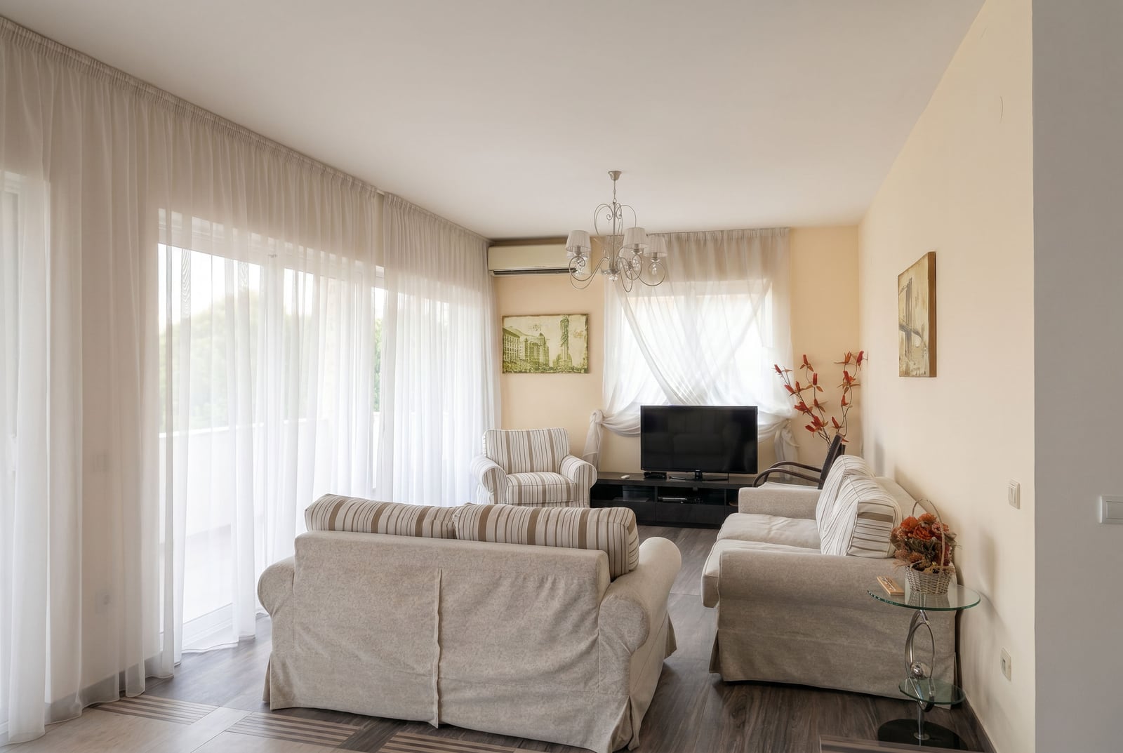 Bright living room with upholstered furniture and panoramic windows in an apartment, Kumbor, Montenegro.