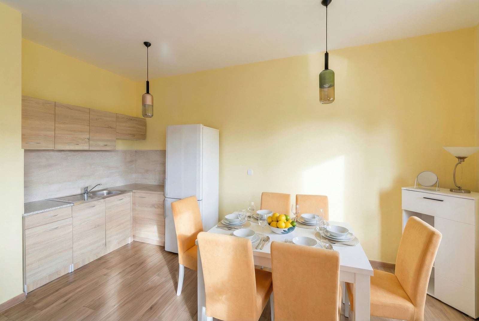Kitchen-dining room with wooden cabinetry and dining area in an apartment in Petrovac, Montenegro.