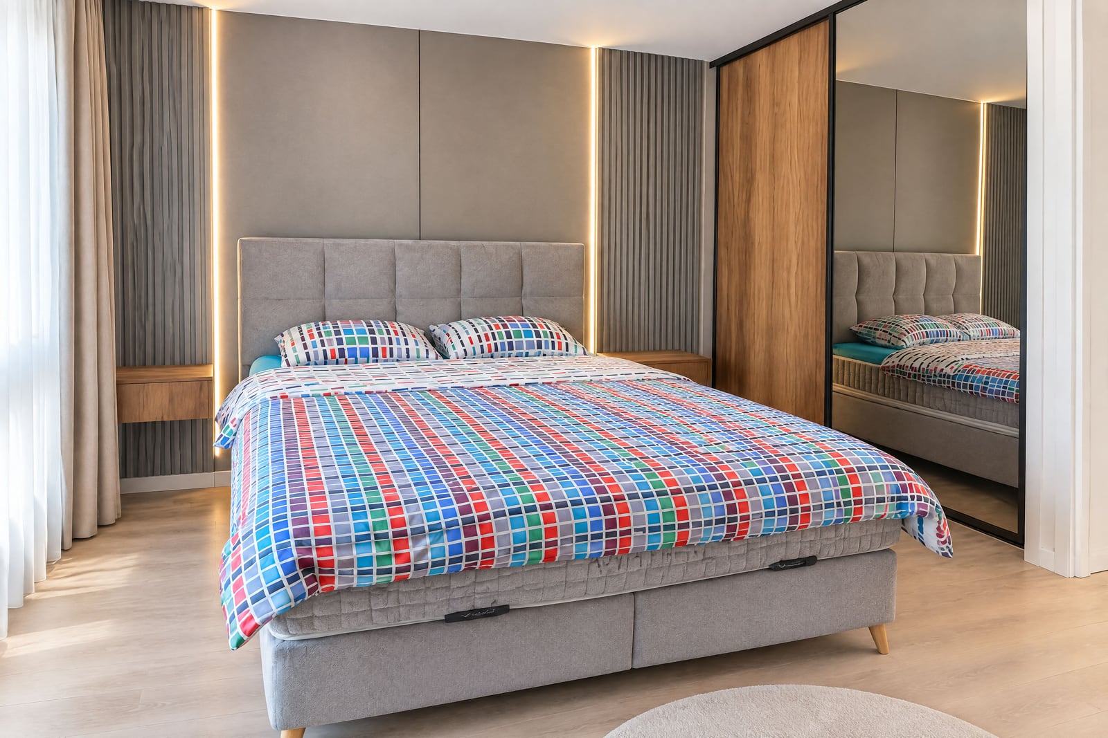 Modern bedroom with a soft bed, a built-in wardrobe, and accent lighting in an apartment in Budva, Montenegro