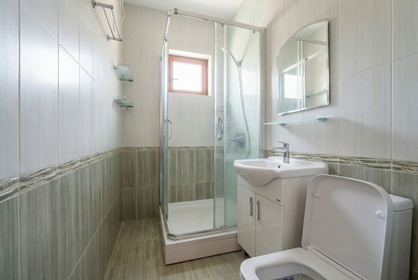 Modern bathroom with a shower cabin, sink, and toilet in an apartment in Igalo, Montenegro