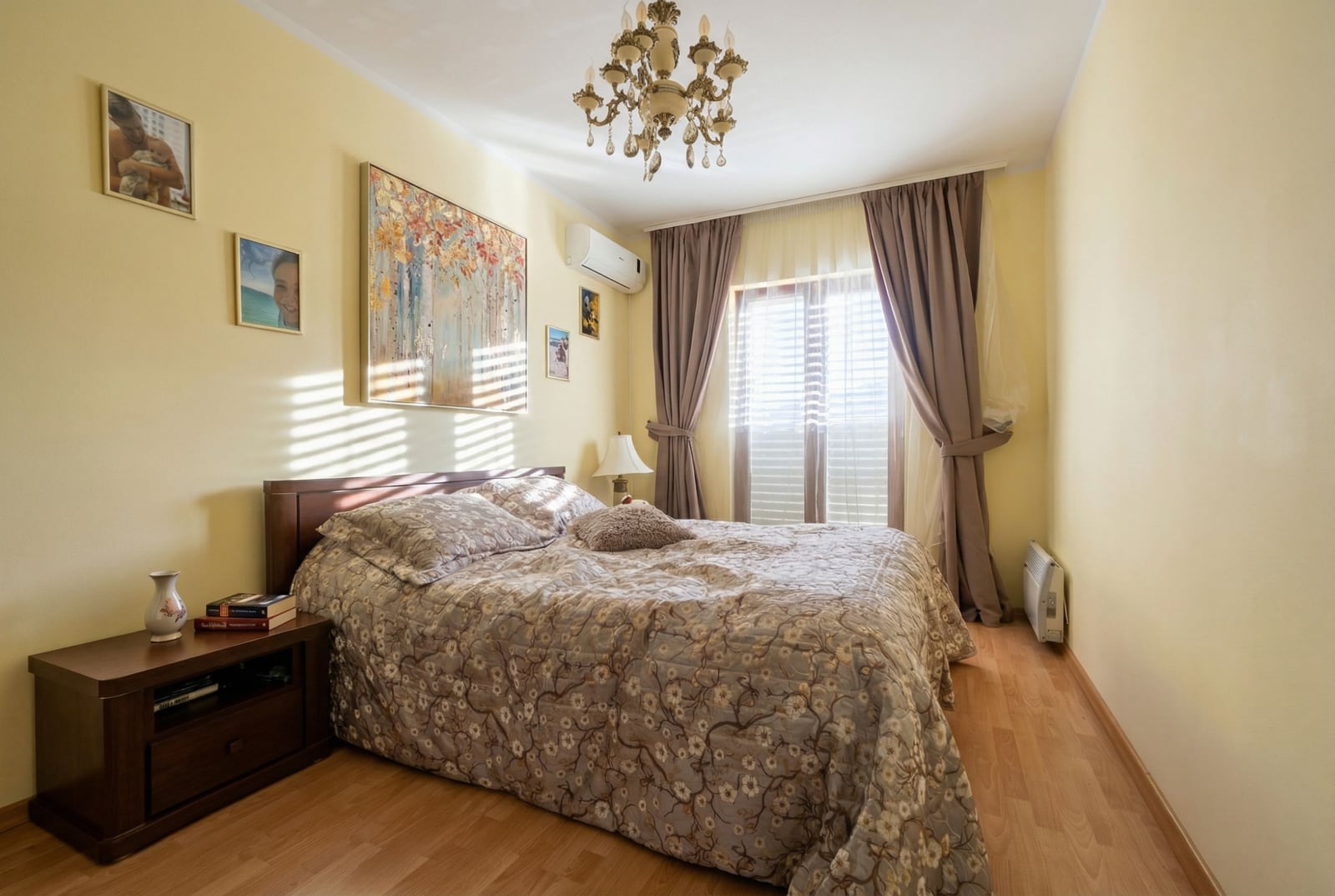 Cozy bedroom with a double bed and paintings in an apartment in Igalo, Montenegro