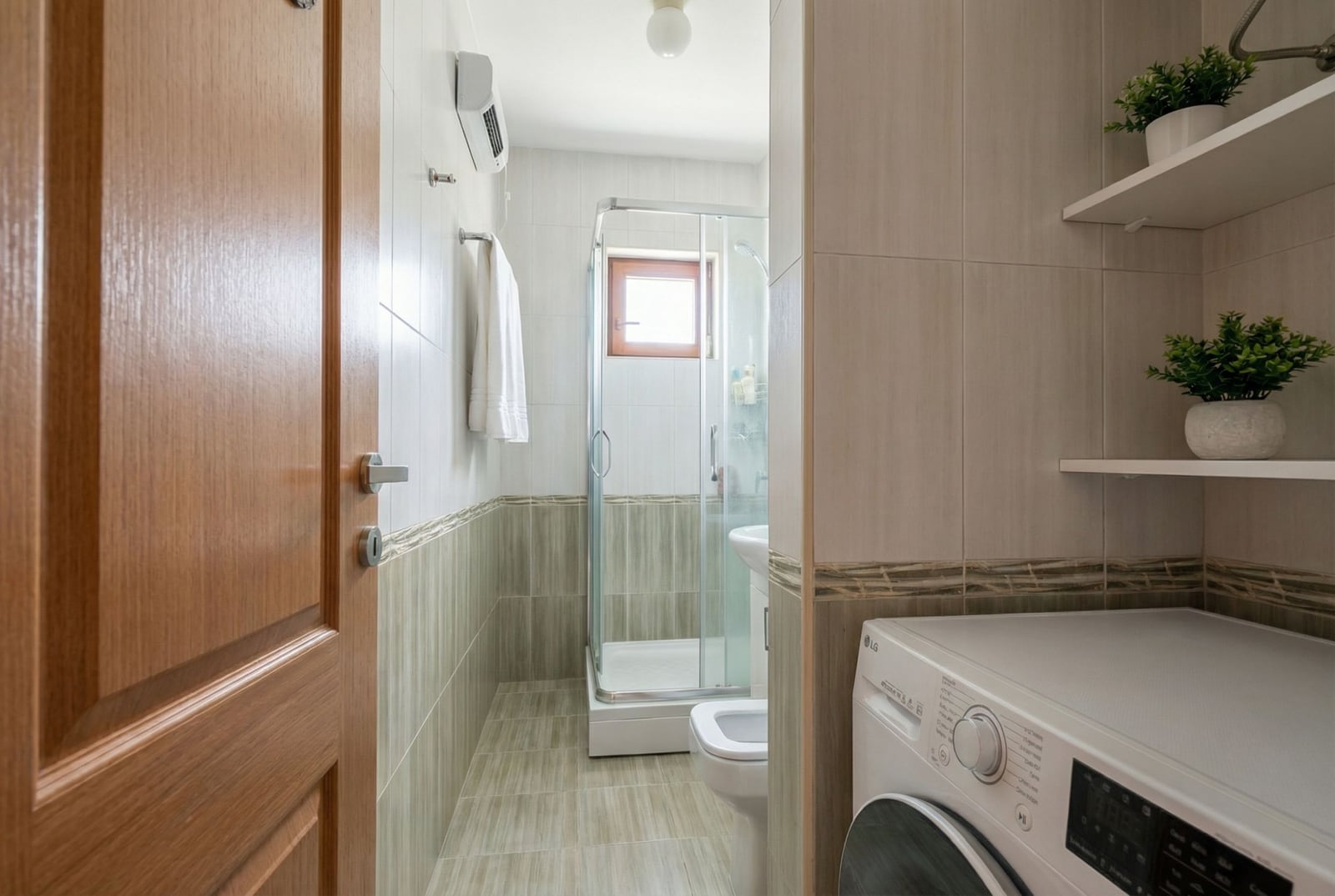 Modern bathroom with a shower cabin and washing machine in an apartment in Igalo, Montenegro