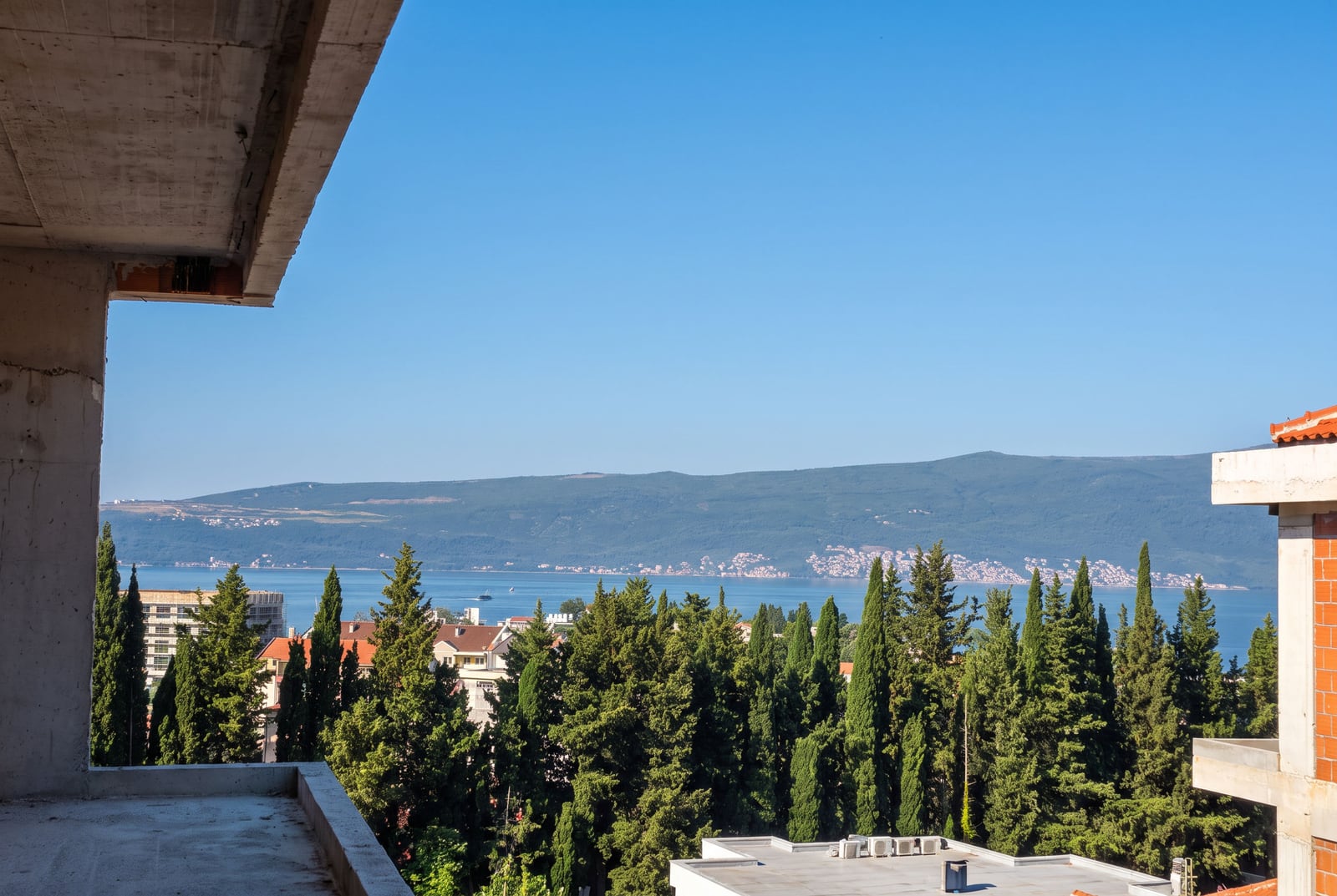 Panoramic view of the sea and mountains from the balcony of a building under construction in Tivat, Montenegro