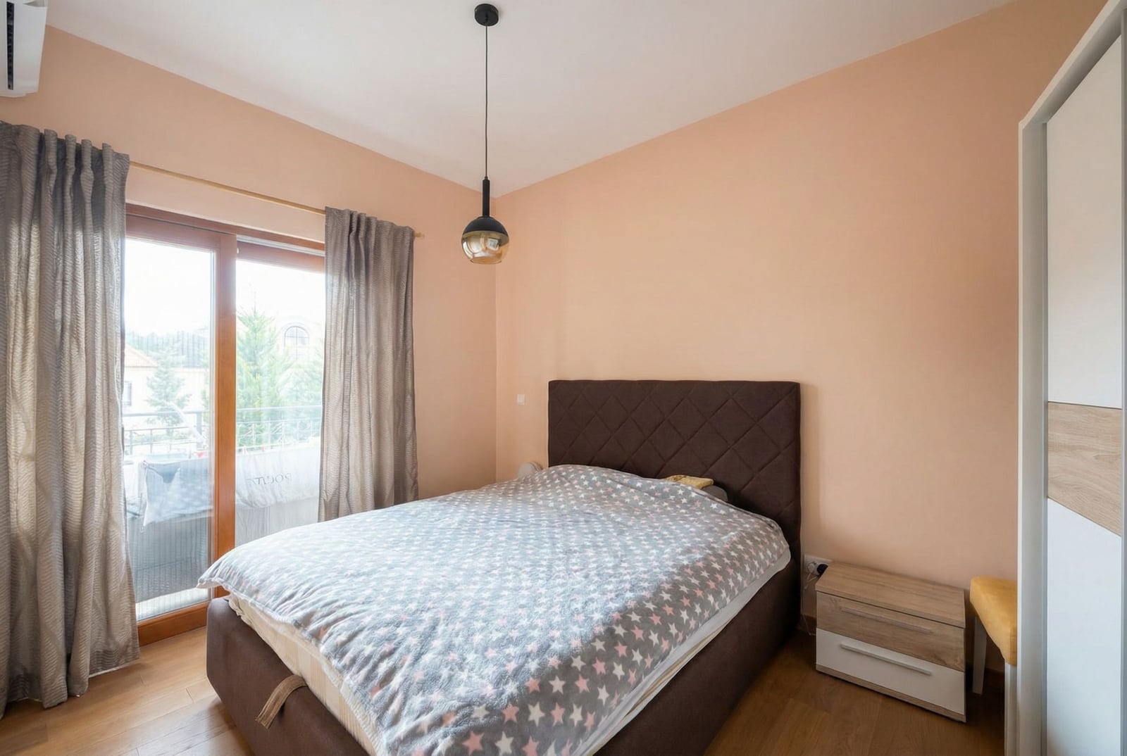 Cozy bedroom with a double bed and access to the balcony in an apartment, Petrovac, Montenegro.