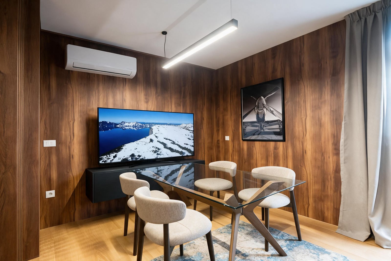 Modern living room with wooden wall paneling, glass table, and TV in an apartment in Budva, Montenegro