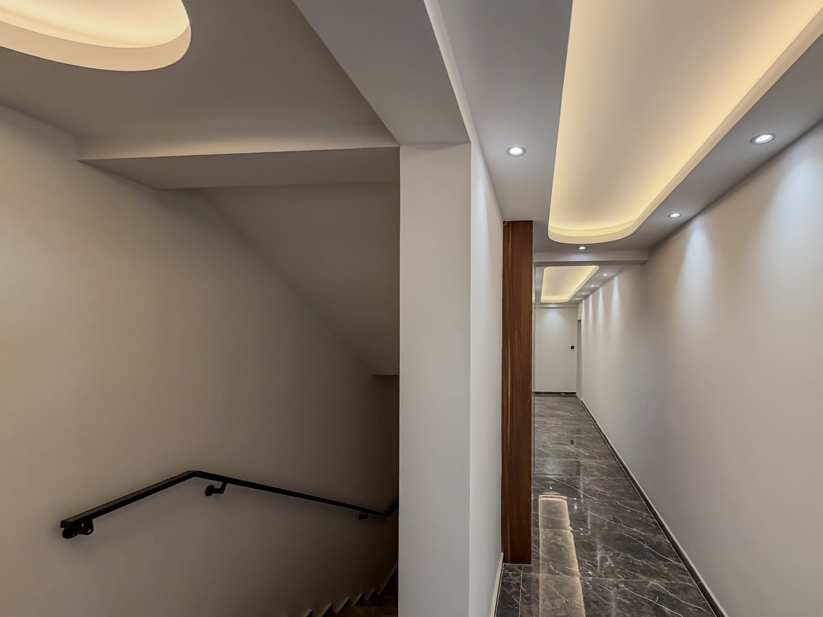 Modern hallway with marble flooring and ceiling lighting in an apartment in Budva, Montenegro
