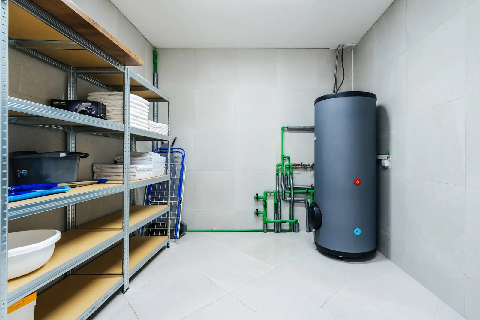 Utility room with a water heater and shelving in a villa in Reževići, Montenegro: tiled finish and engineering systems.