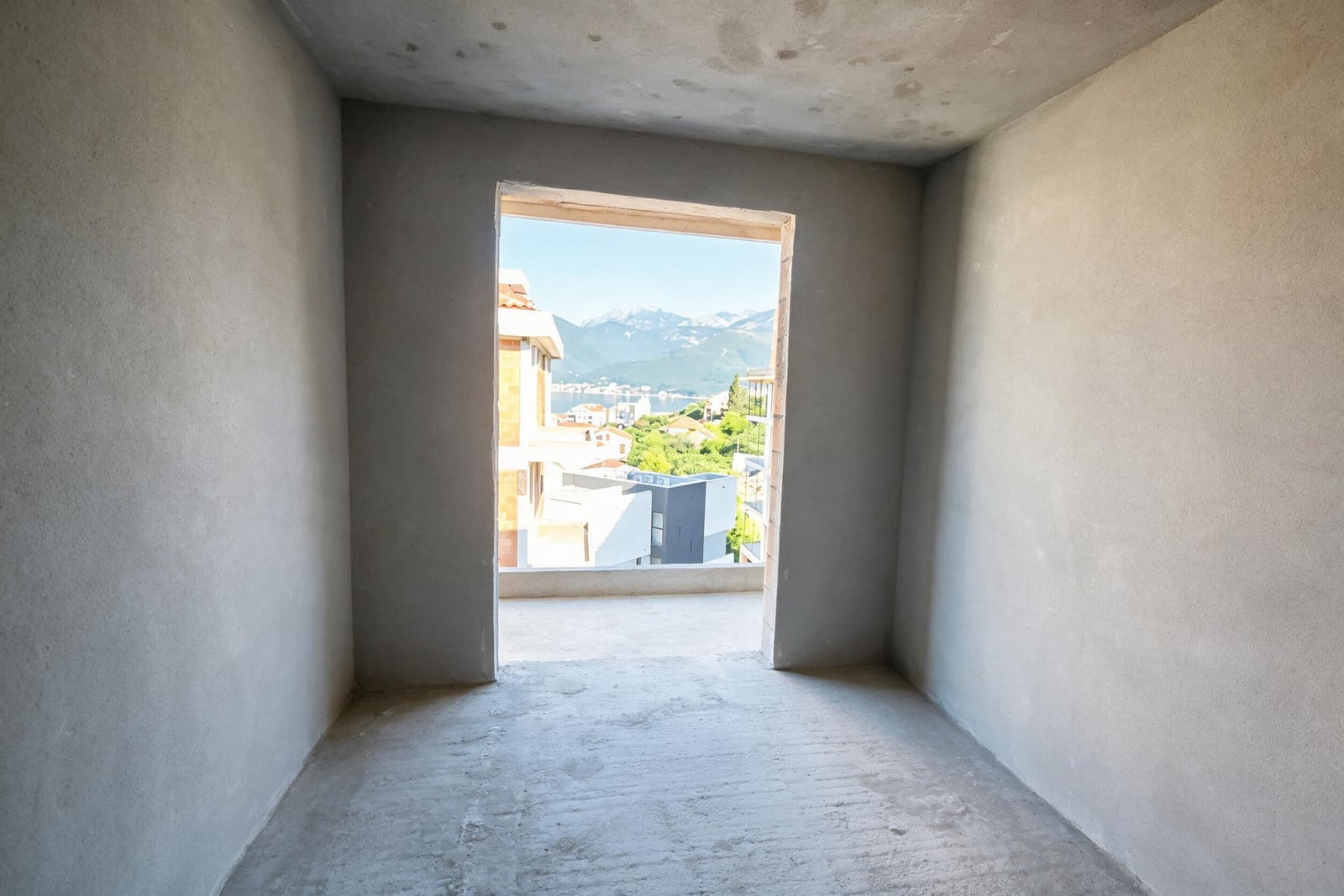 Apartment in Tivat, Montenegro: unfinished bedroom with access to a balcony and mountain views.