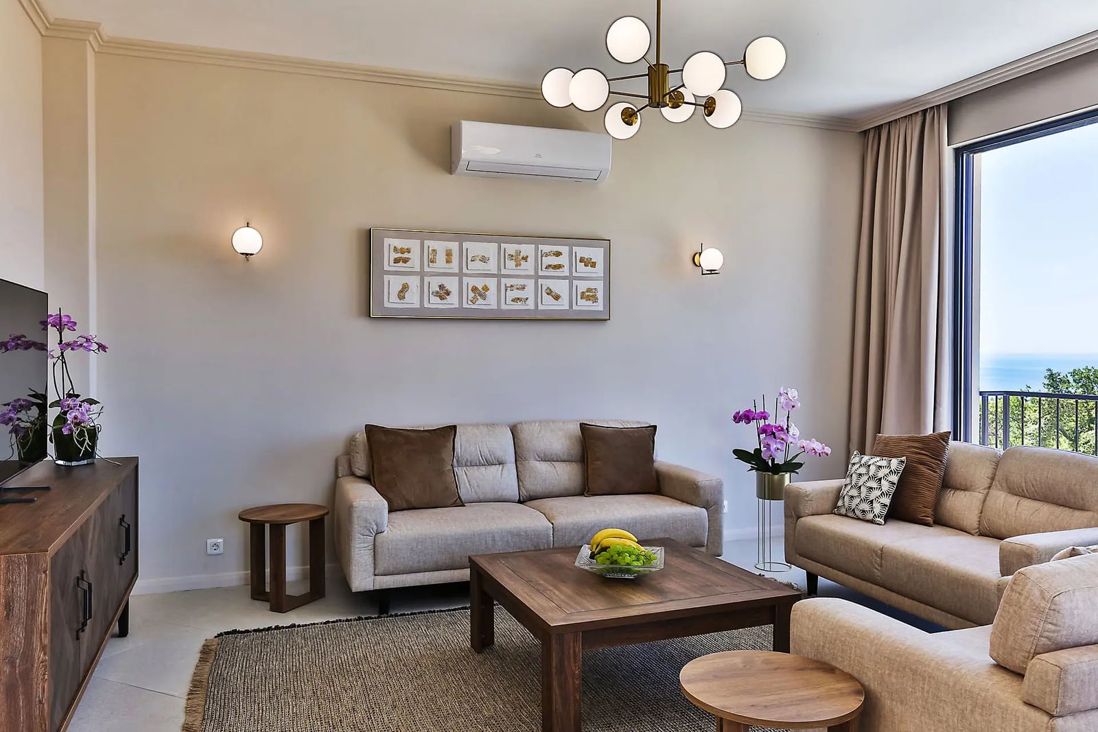 Modern living room with upholstered furniture and sea views in a villa, Reževići, Montenegro: stylish interior with decor.