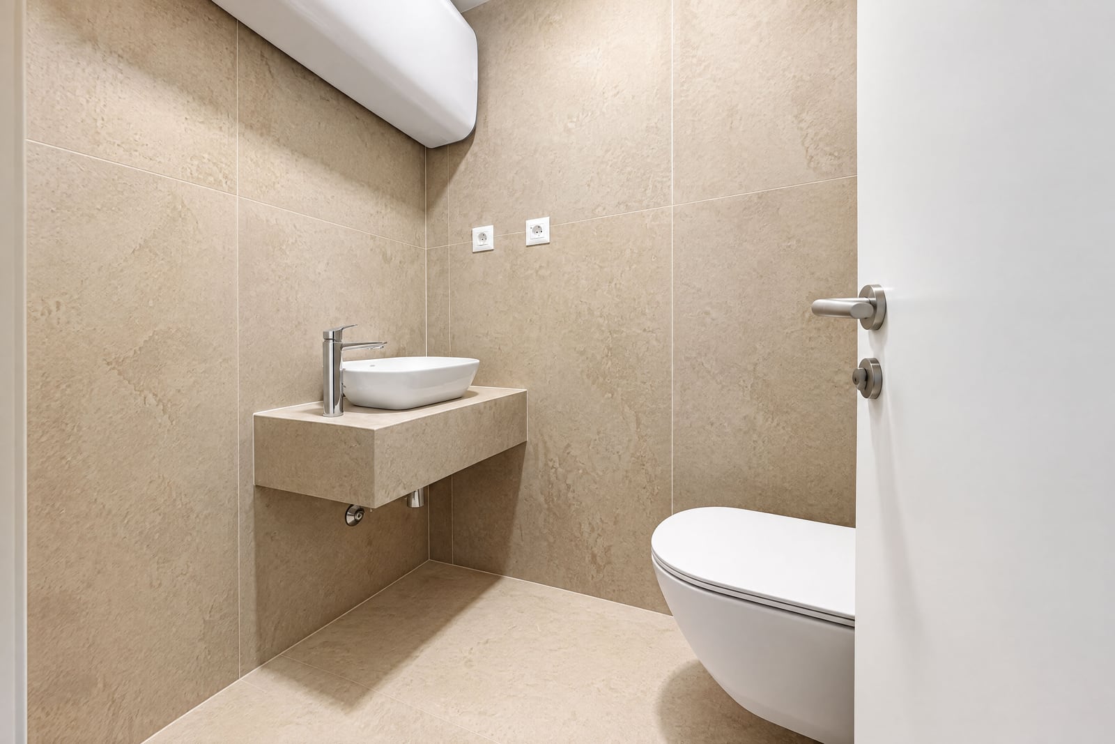 Modern bathroom with white fixtures and beige tiles in an apartment in Becici, Montenegro