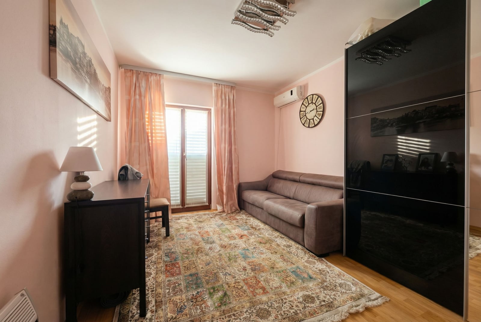 Cozy living room with a sofa, dark cabinet, and carpet in an apartment in Igalo, Montenegro