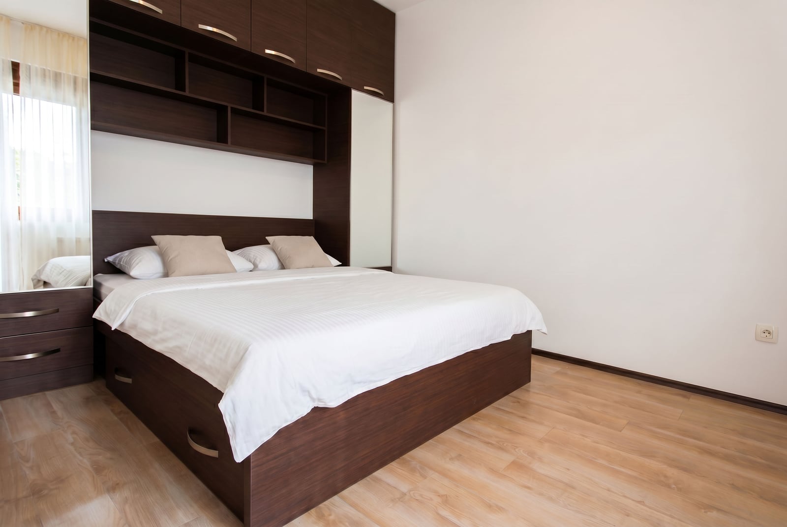Modern bedroom with a double bed and a built-in wardrobe in an apartment in Budva, Montenegro.