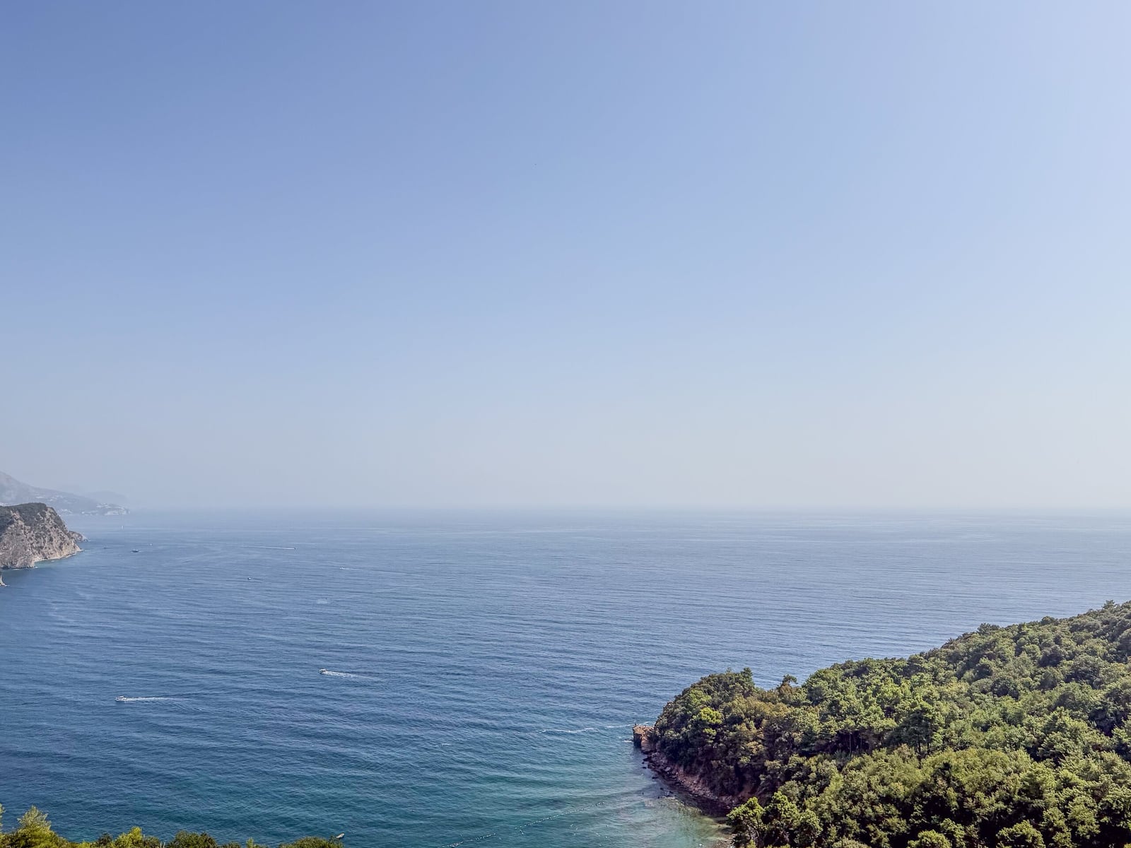 Panoramic view of the Adriatic Sea and green hills from an apartment in Budva, Montenegro