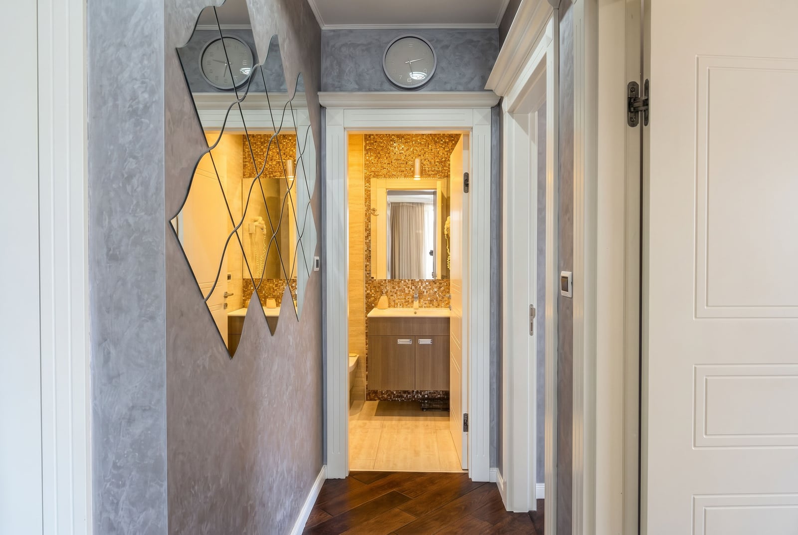 Interior of the hallway and bathroom in an apartment, Budva, Montenegro: decorative mirror, wall finishes, and tiling.