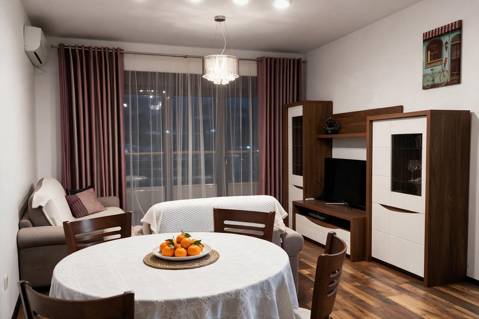 Cozy living room with dining area, wooden furniture, and panoramic window in an apartment in Budva, Montenegro